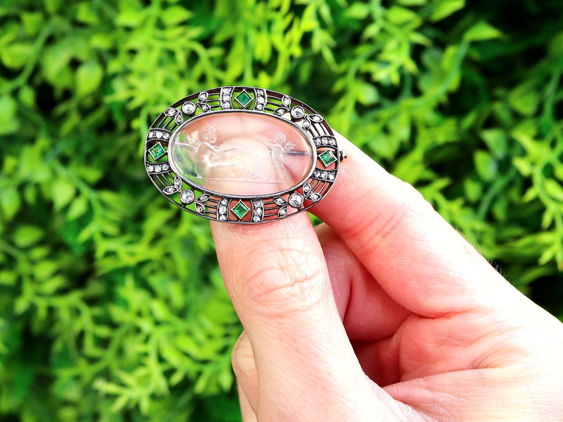 A stunning, fine and impressive antique crystal, 0.14 carat emerald, 0.58 carat diamond, 18 karat yellow gold and silver set Cupid and Psyche brooch; an addition to our collection of Victorian jewelry.

This stunning, fine and impressive antique