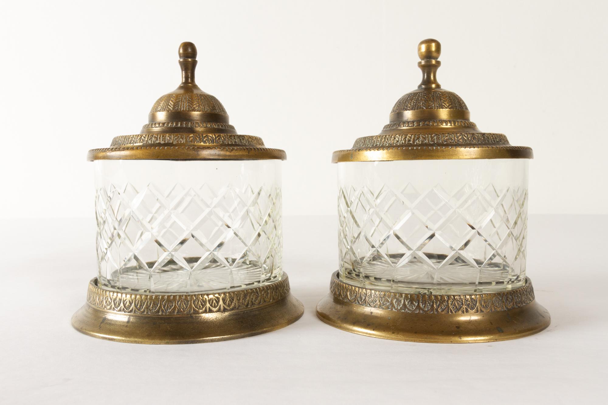 Antique crystal and bronze jars 19th century.
Rare pair of vanity or dresser jars in cut crystal with bronze lid and base. Lid and stands are decorated with a fine pattern. Probably French from late 19th century. 
Very good condition. No chips or