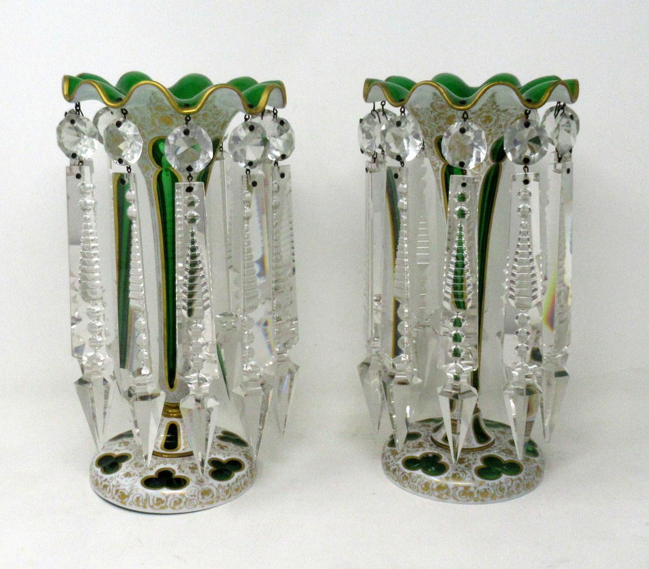A stylish example of a fine pair of Bohemian emerald green gilt heightened white enamel handcut full lead crystal lusters of outstanding quality and of standard proportions. Third quarter of the 19th century, possibly earlier.

Each with unusual