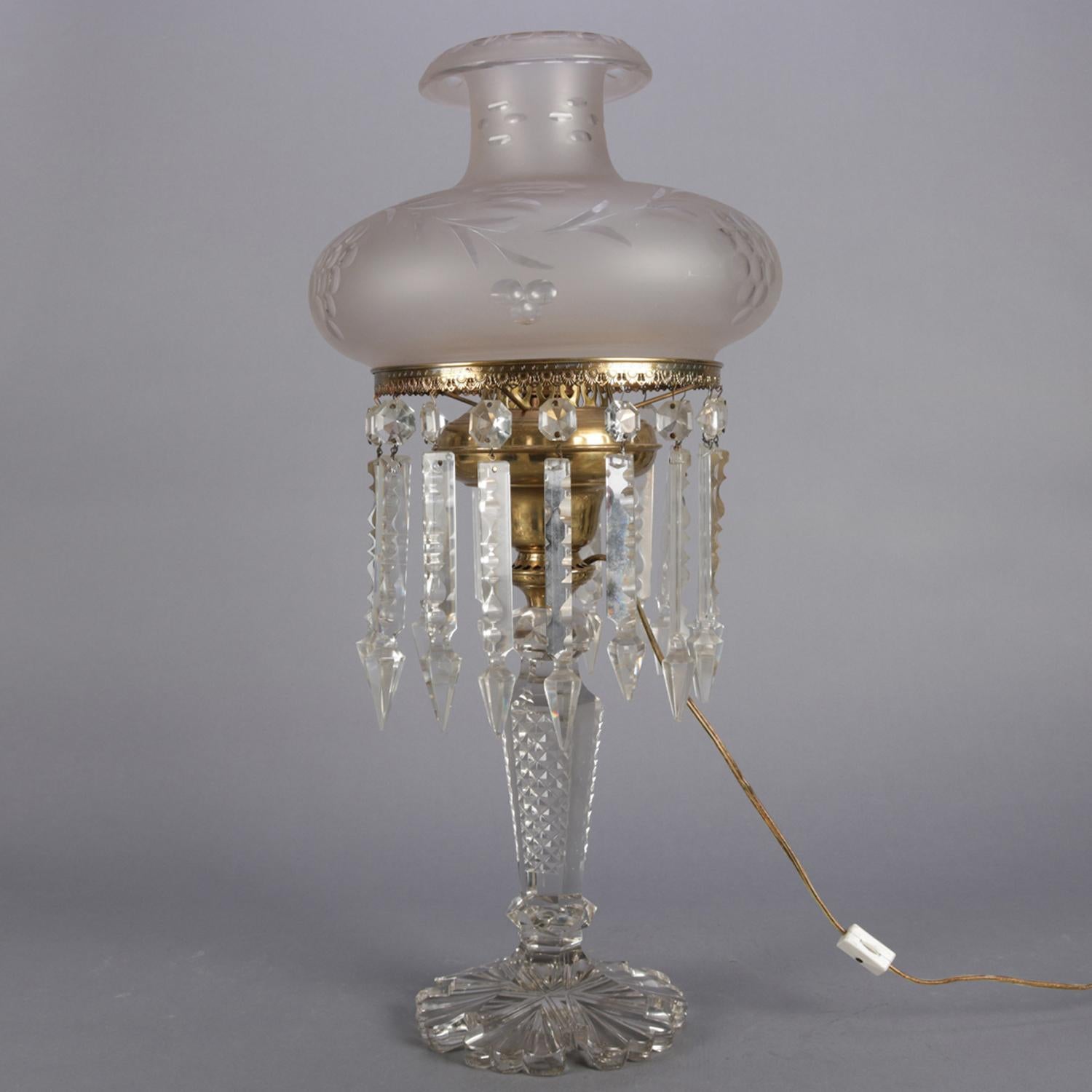 Antique crystal J.G Webb solar lamp features brass font over pressed glass base having tapered and diamond patterned column over foot reminiscent of snowflake design, frosted glass shade with floral and foliate design and seated on fitter with