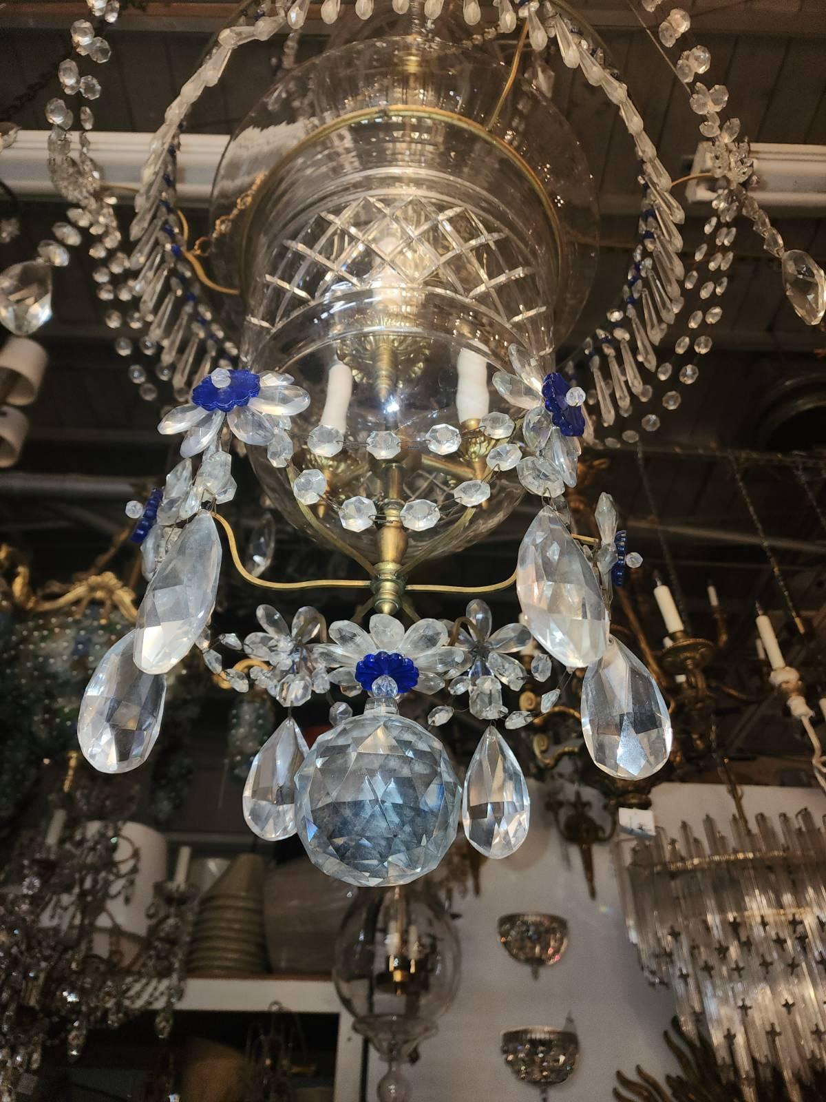 19h Century Crystal Chandelier with flower mounted with blue centers, and beaded chains and prisms.