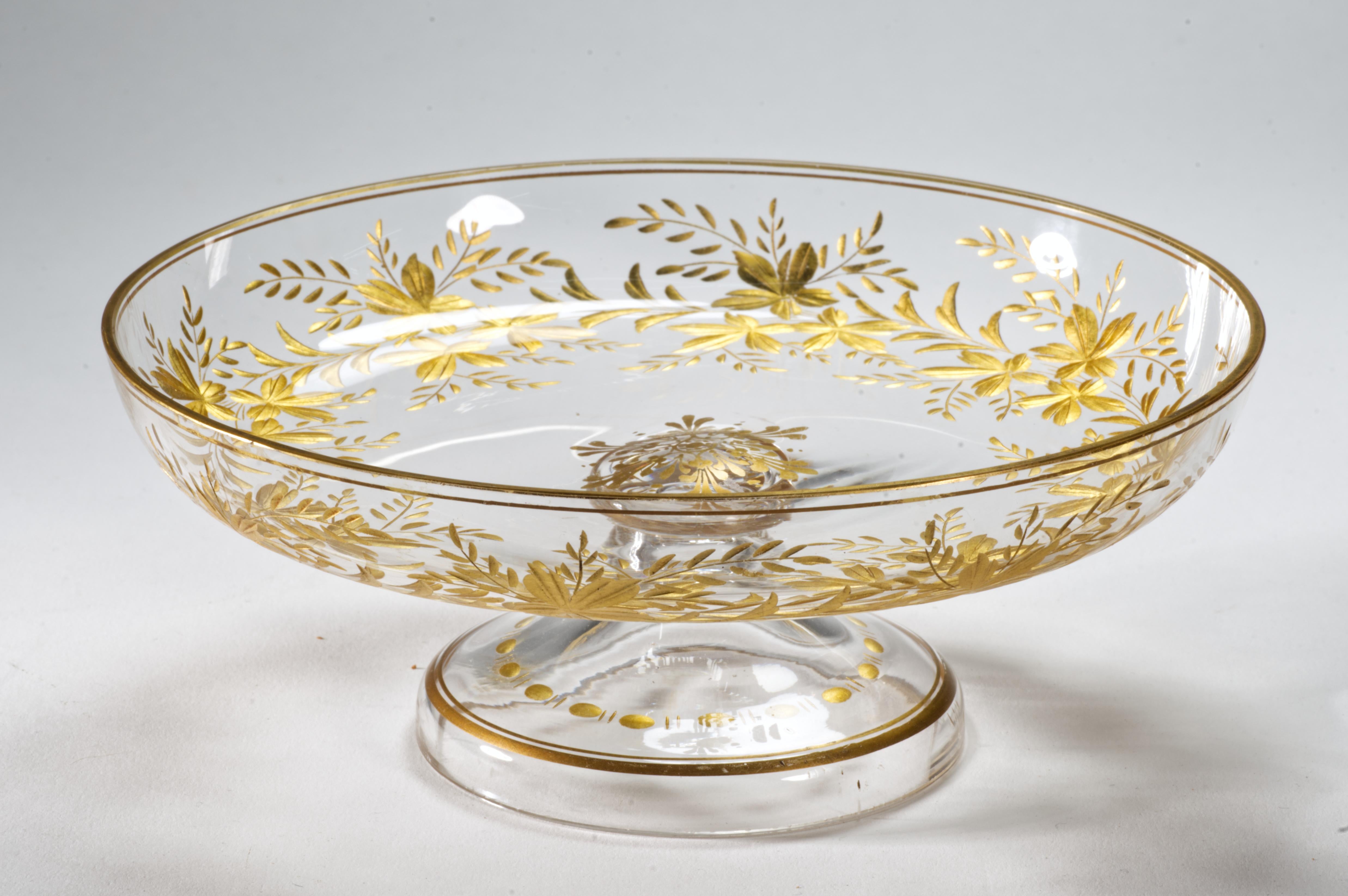 
Antigua tazza o cuenco con pie de cristal de Bohemia con decoración abstracta grabada en calcografía y dorada con guirnaldas. El dorado dorado a lo largo del borde se acentúa con el borde cortado, creando las superficies ligeramente festoneadas del