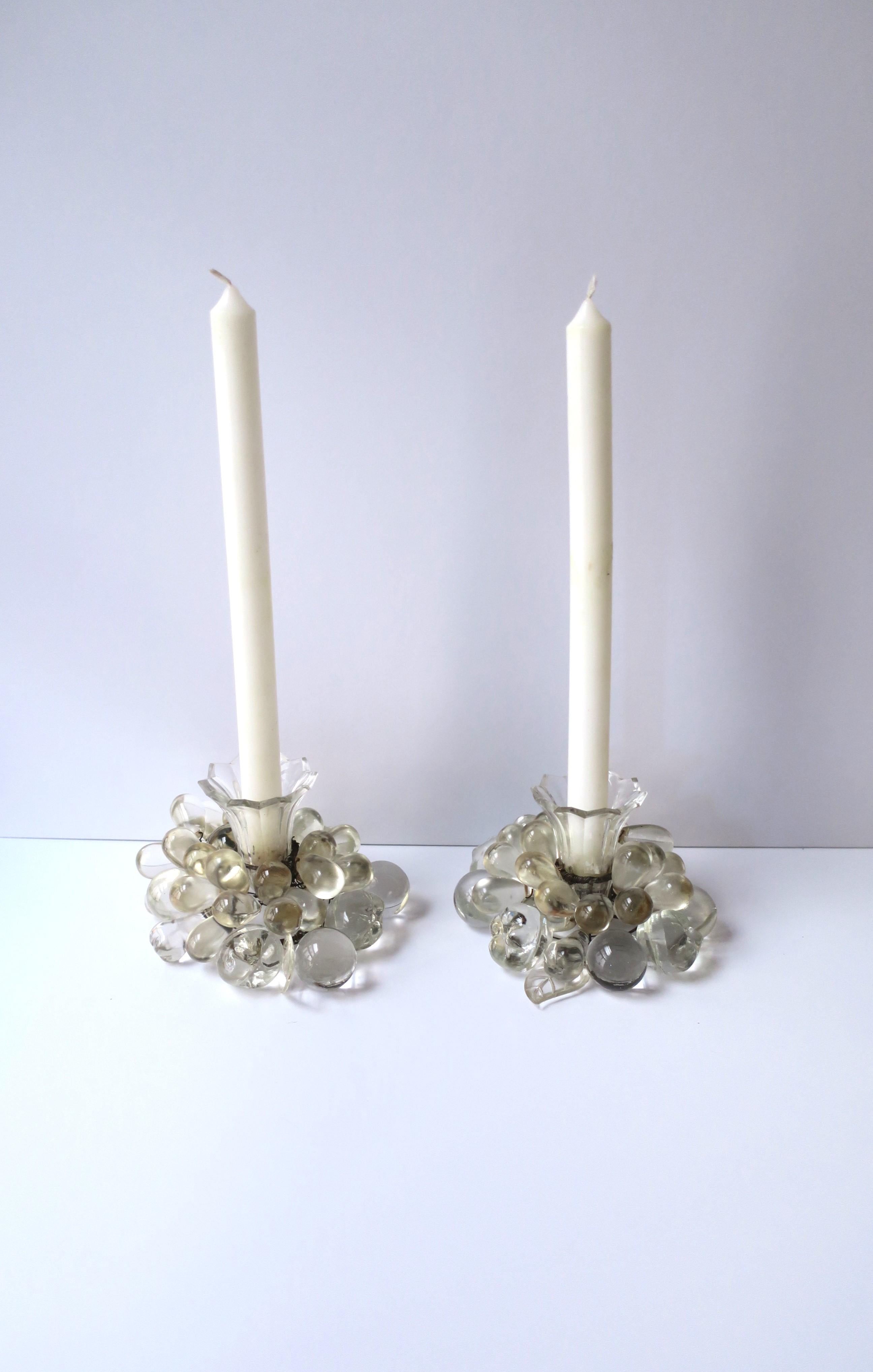 A pair of crystal fruit and leaf candlestick holders, Art Deco period, circa early-20th century, Czechoslovakia. Pair encompass crystal grapes, other fruits, and leaves, with cut crystal candle holder. A beautiful set for dining, entertaining,