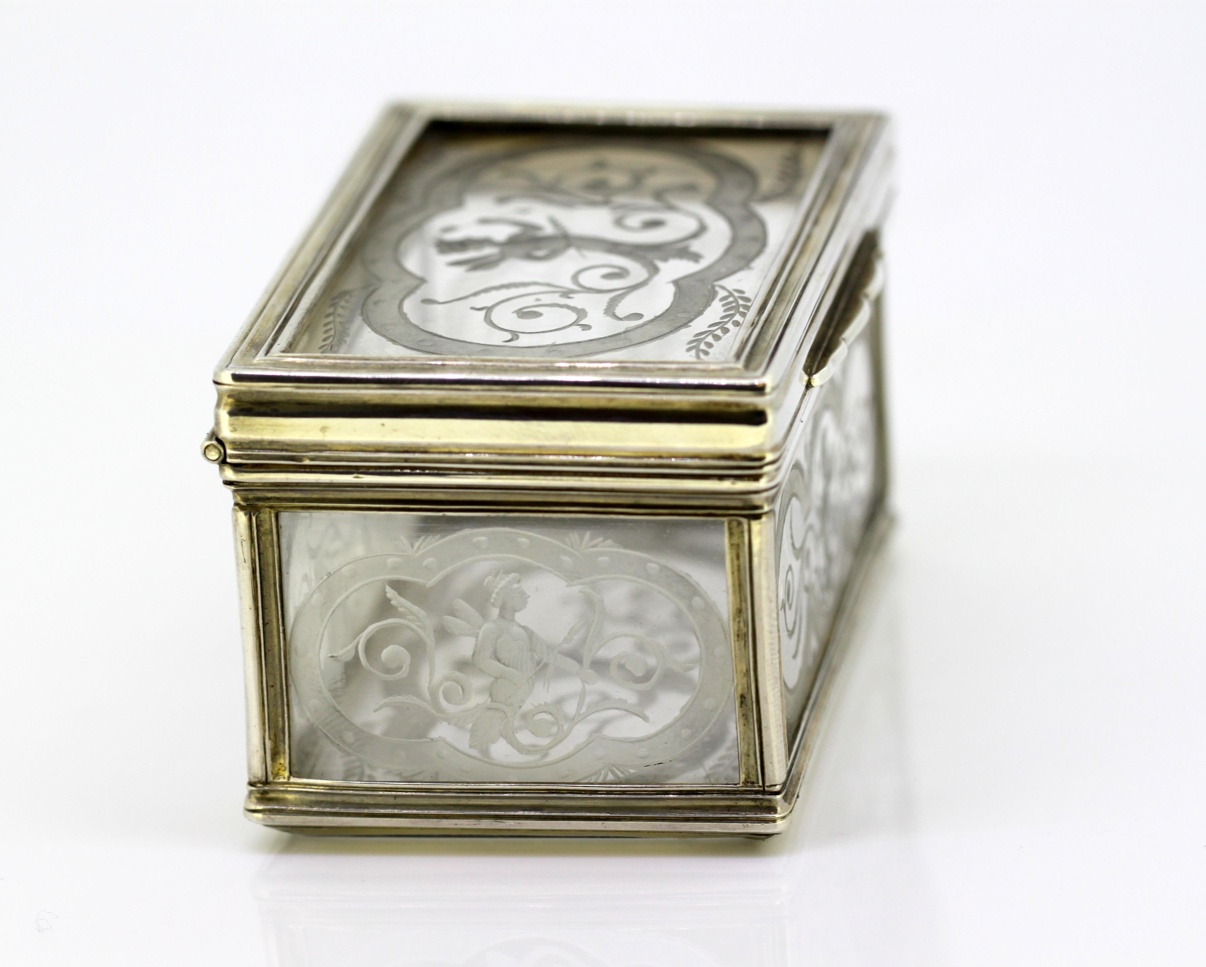 Antique crystal glass and silver snuff / pill box. ecorated with various angelic cherub like figures and floral scriptures.

Made in France, 17th century, circa 1680.

Dimensions: 
Length 7.8 cm
Width 5 cm
Height 4.6 cm
Weight 189