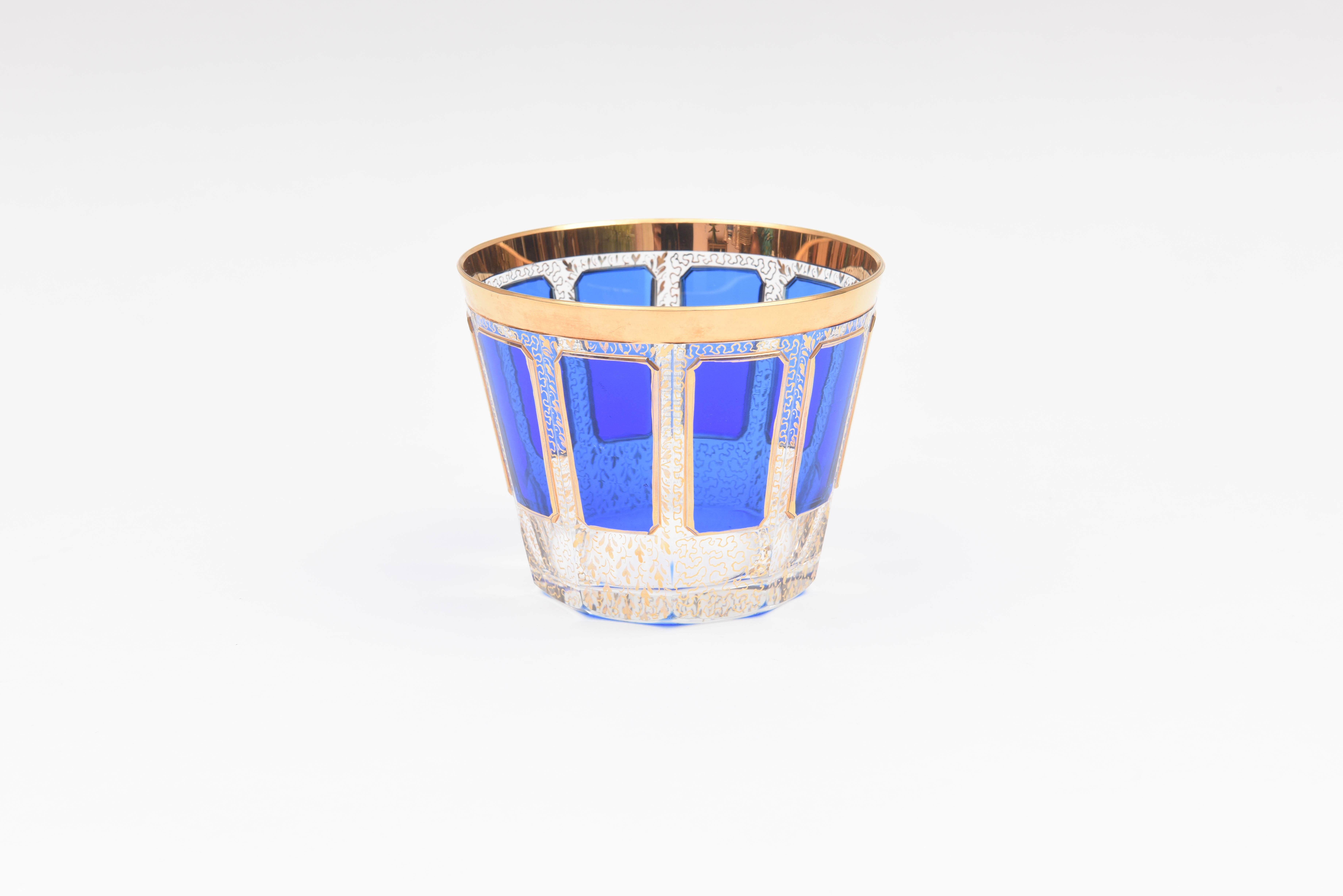 A sweet cut-glass ice bucket or wine cooler with Moser's signature elongated cabochon panels in cobalt blue glass and accented with hand-trimmed 24-karat gold and a modified gilt scroll panel throughout. In very nice antique condition.
