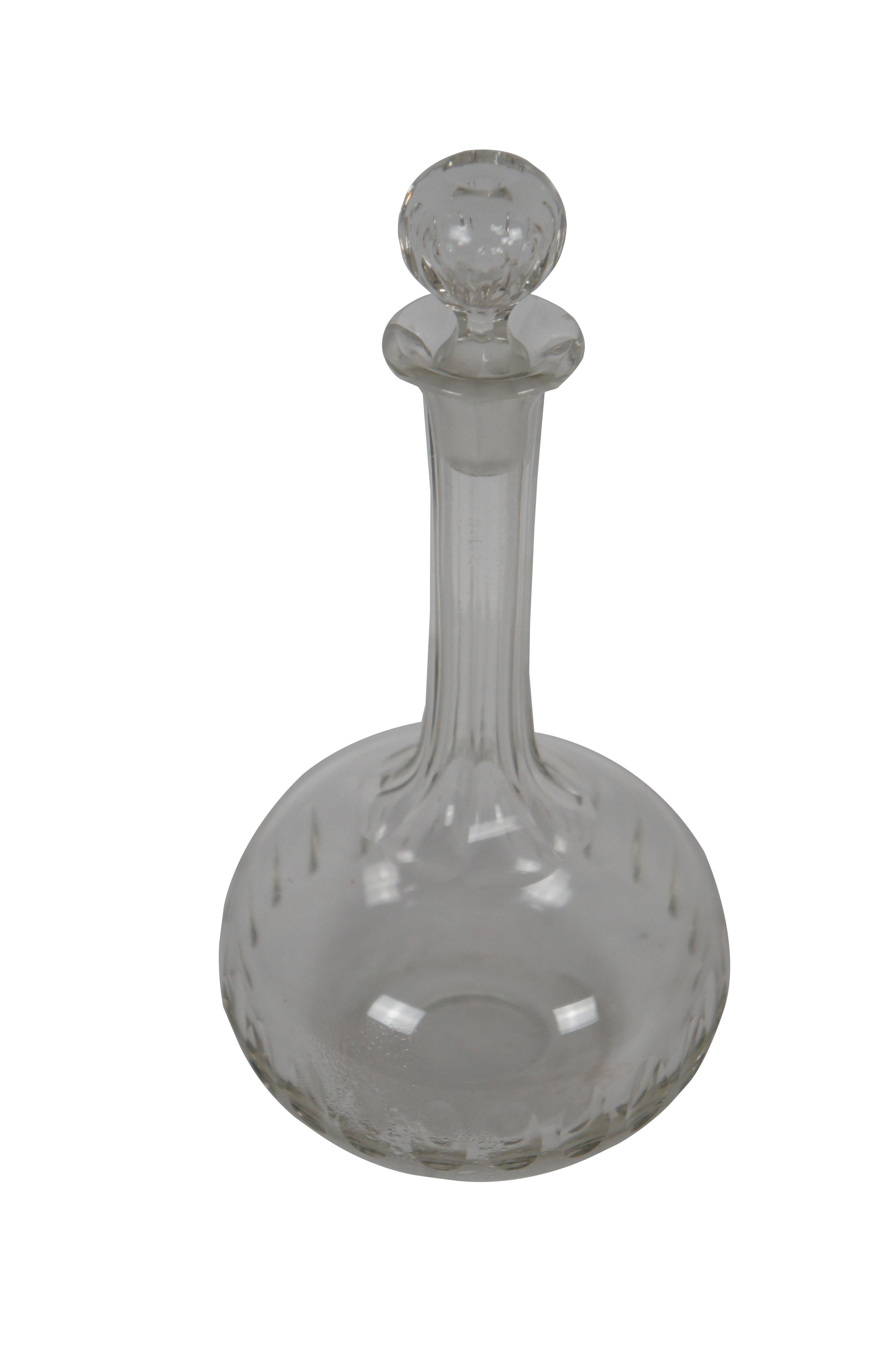 Early 20th century clear cut glass decanter and stopper. Bulb shaped base decorated with a ring of thumbprint dots, narrow faceted neck and orb shaped stopper also imprinted with ovals.

Dimensions:
4.5