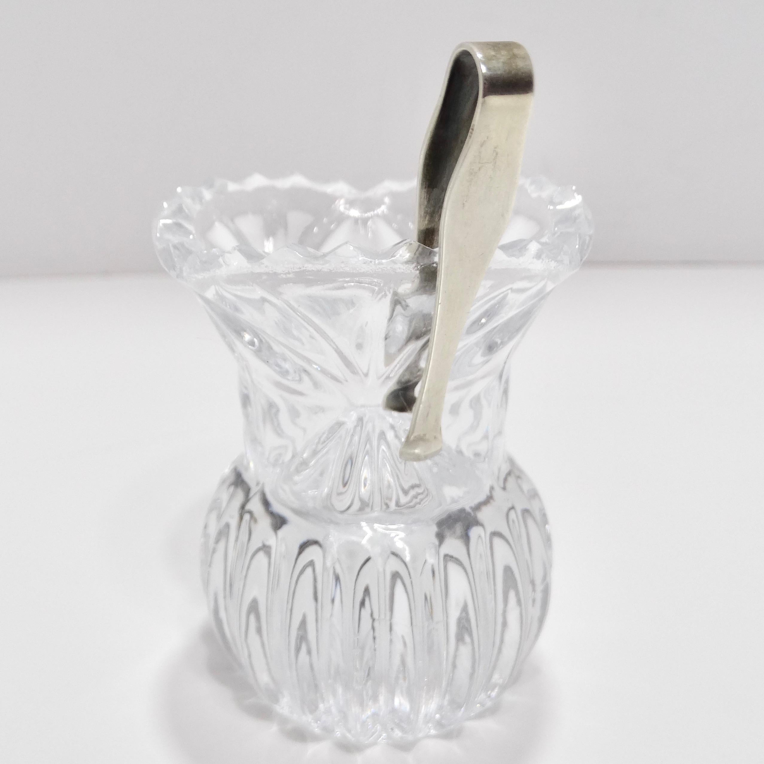 Introducing the Antique Crystal Toothpick Holder & Silver Serving Tongs, a stunning fusion of beauty and functionality that adds a touch of opulence to your dining experience.

Crafted from clear crystal, the toothpick holder doubles as a mini vase,