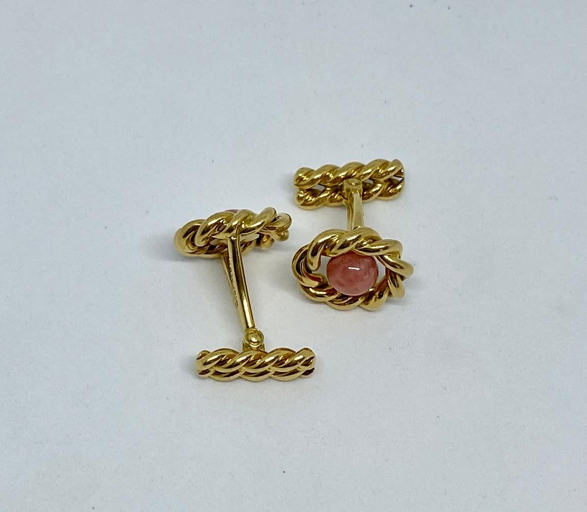 Stunning cufflinks in solid, 18K yellow gold featuring rhodochrosite cabochons. When viewed on the shirt cuff, the rhodochrosites appear to float in the center of yellow gold 