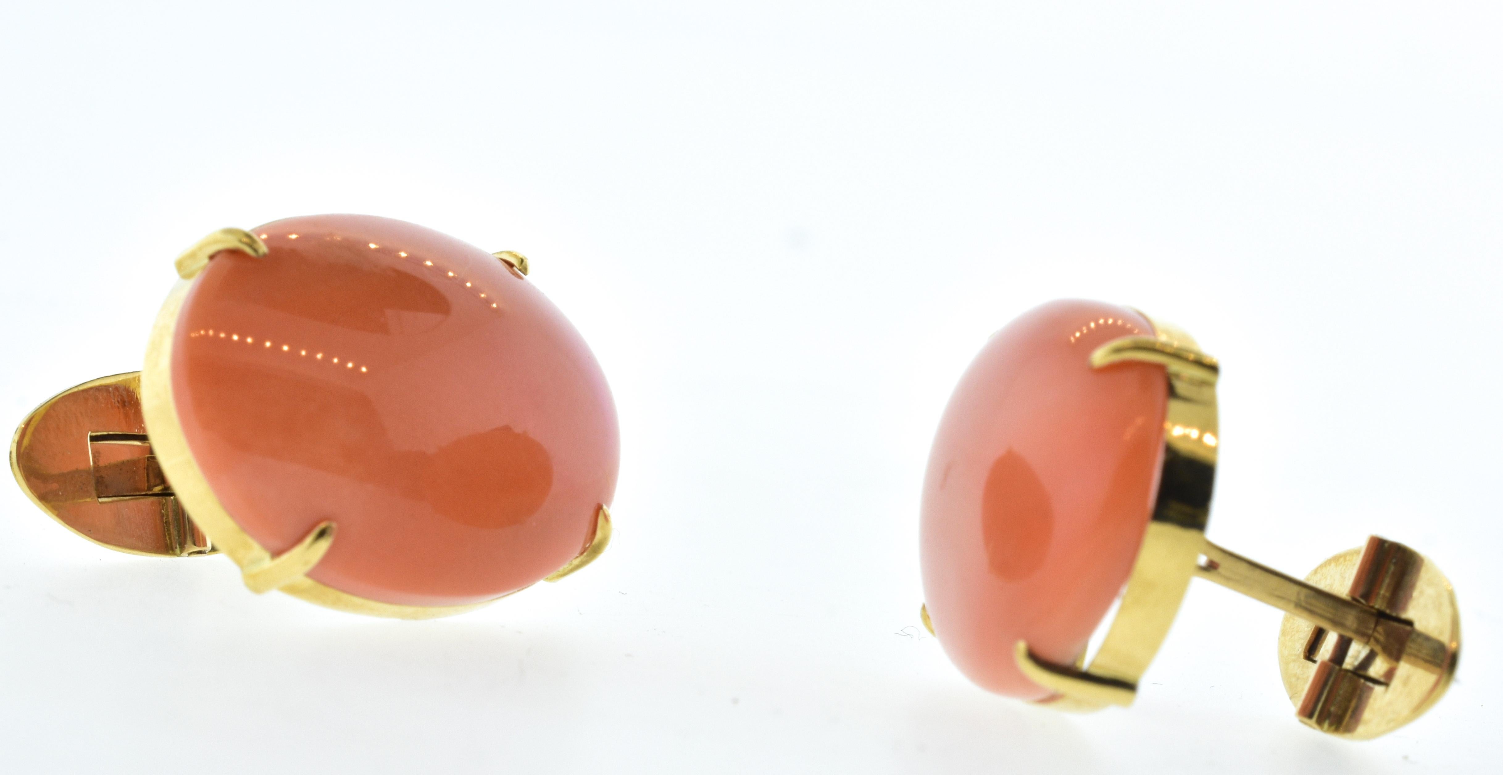 Antique cufflinks centering fine large natural coral.  The natural coral is an even fine tomato color and prong set in gold.  The back swivels in for ease when putting on.  The coral measures 1 inch in diameter.  These antique cufflinks are bold,