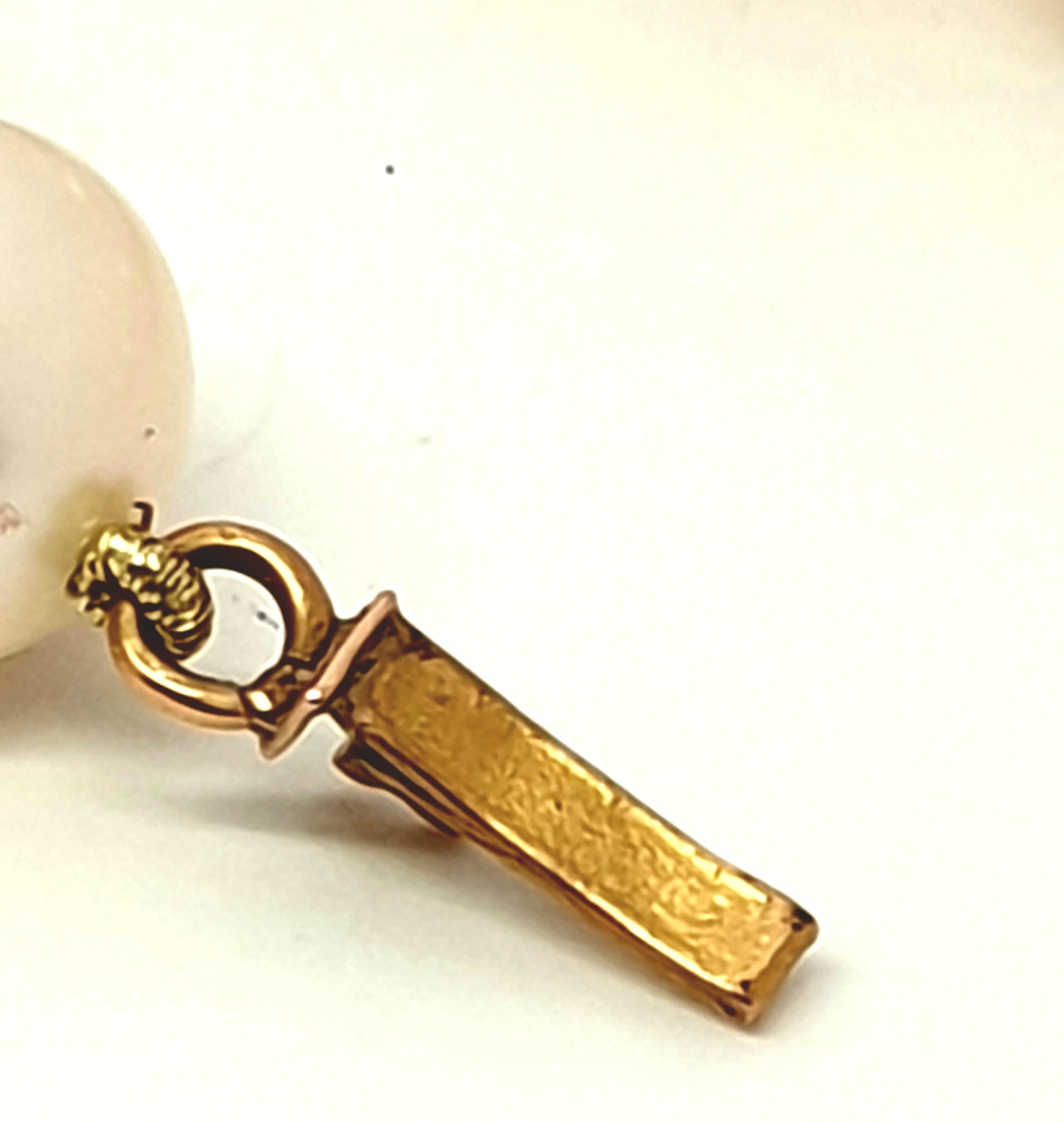 Offering an antique cultured pearl necklace. French origin. An 18 Kt yellow gold pendant is attached  to the necklace very light weight,not hallmarked but tested as 18 kt gold. The clasp is also 18 kt gold. The necklace length is 42 cm  long. The