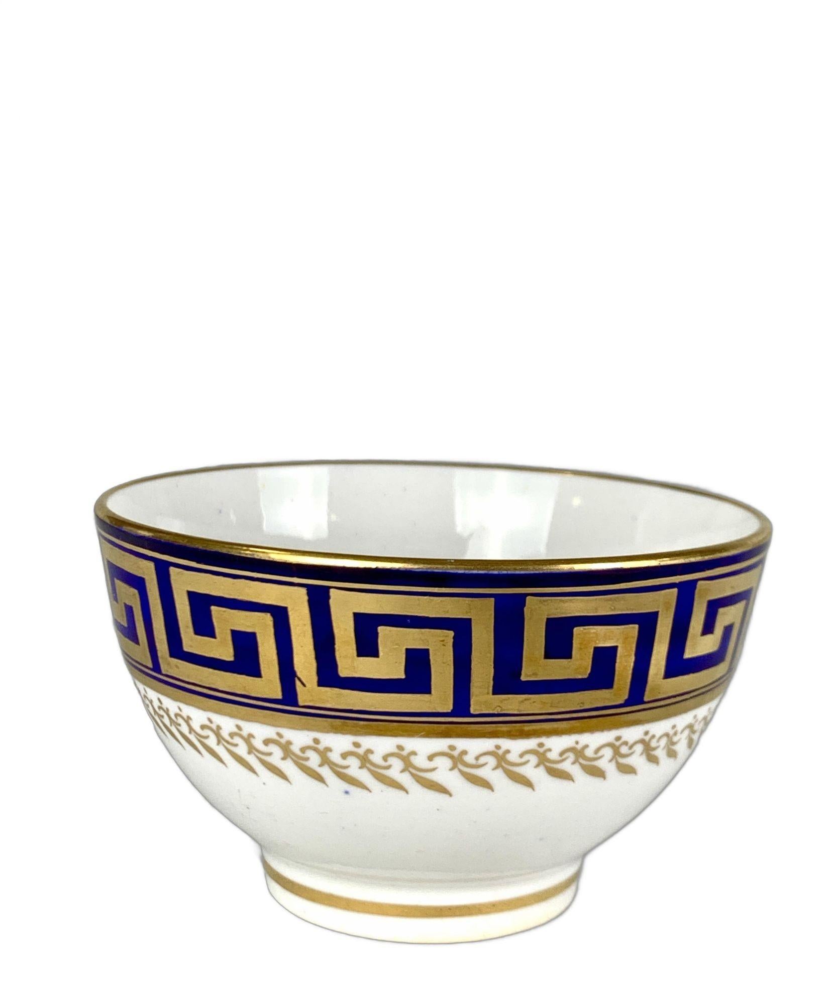 This elegant antique porcelain tea bowl and saucer were hand-painted at Coalport Porcelain in England circa 1820.
They are decorated in the Regency style with a band of gilded Greek key design on a beautiful deep royal blue ground.
This is a