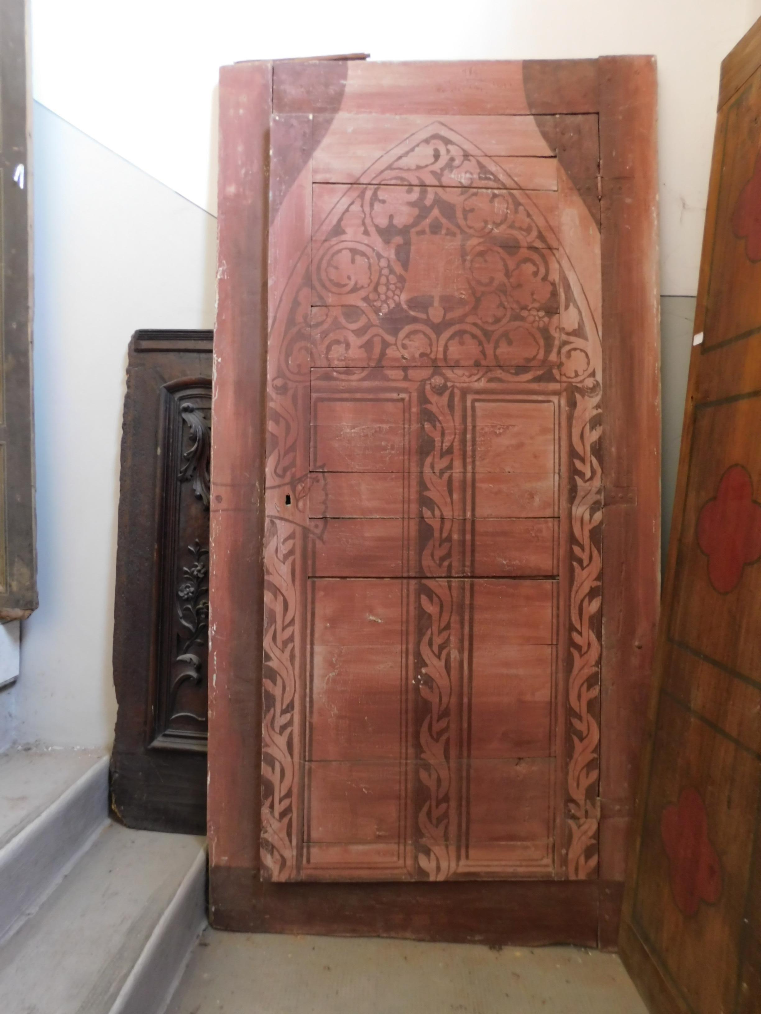 Ancient wall placard, cupboard, can also be used as an interior door if the lower base is cut, in soft wood, red painted with arched motifs, almost arabesque and with vines or vegetation, from the Langhe winery in Italy, built in the epoch 800,