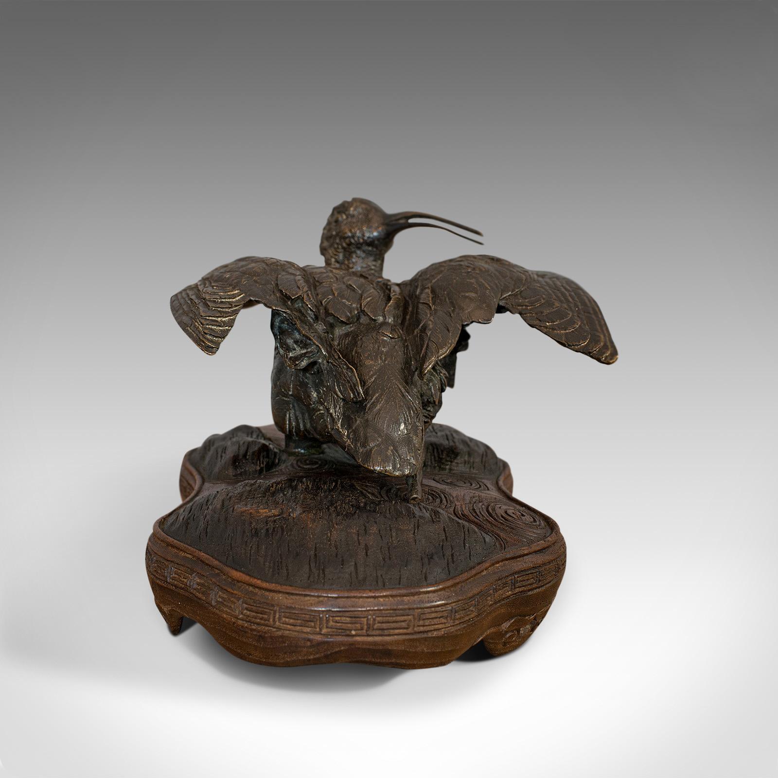 This is an antique study of a curlew. An Oriental, bronze and mahogany decorative small bird, dating to the late 19th century, circa 1900.

The bird sculpted in a sunbathing pose with wings raised
Displays a desirable aged patina
Curlew in