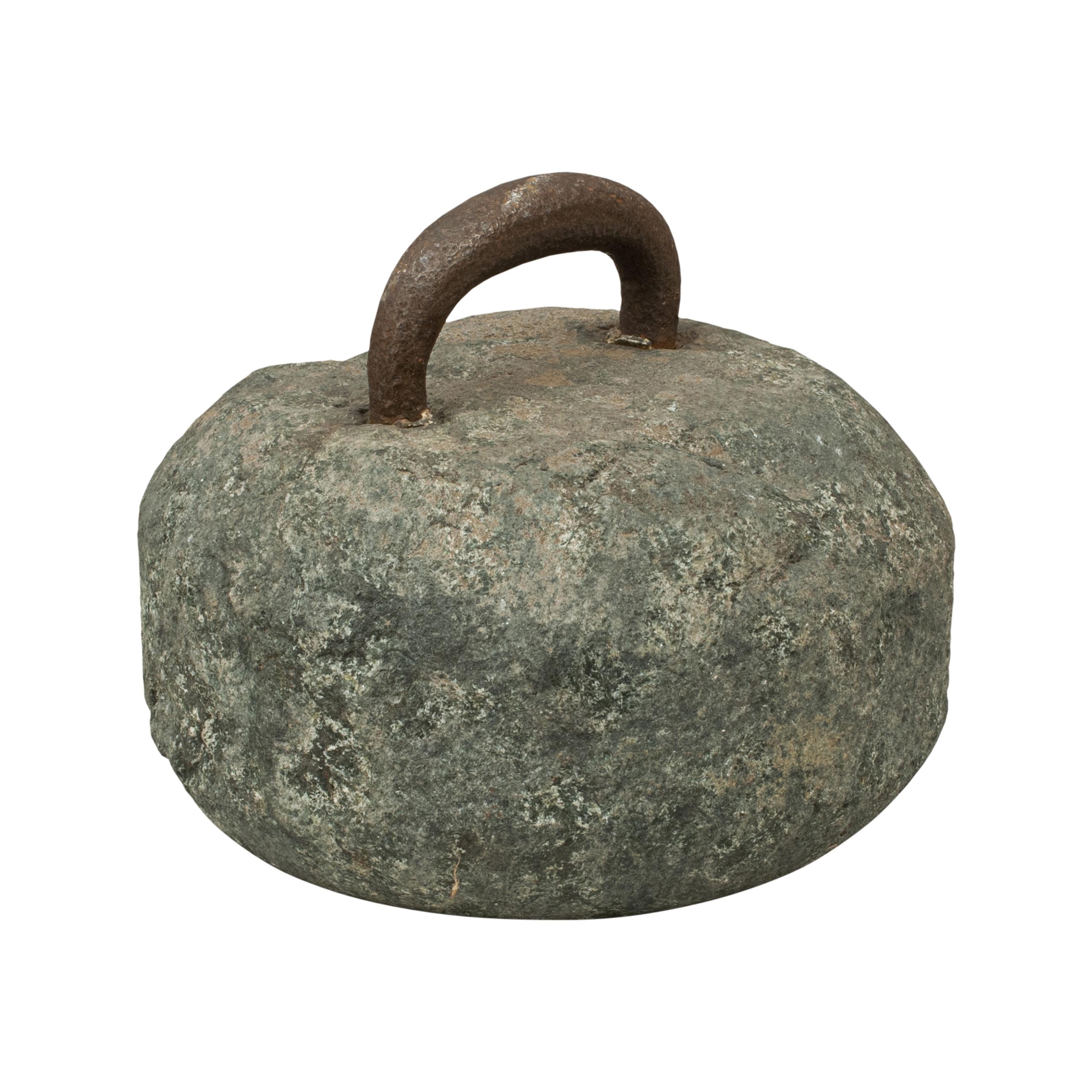 Early antique curling stone.
A fine early single-soled curling stone with a forged iron metal handle. The metal handle is permanently fixed with lead into holes bored into the top of the stone. There is a beautiful roughness to the stone, it is