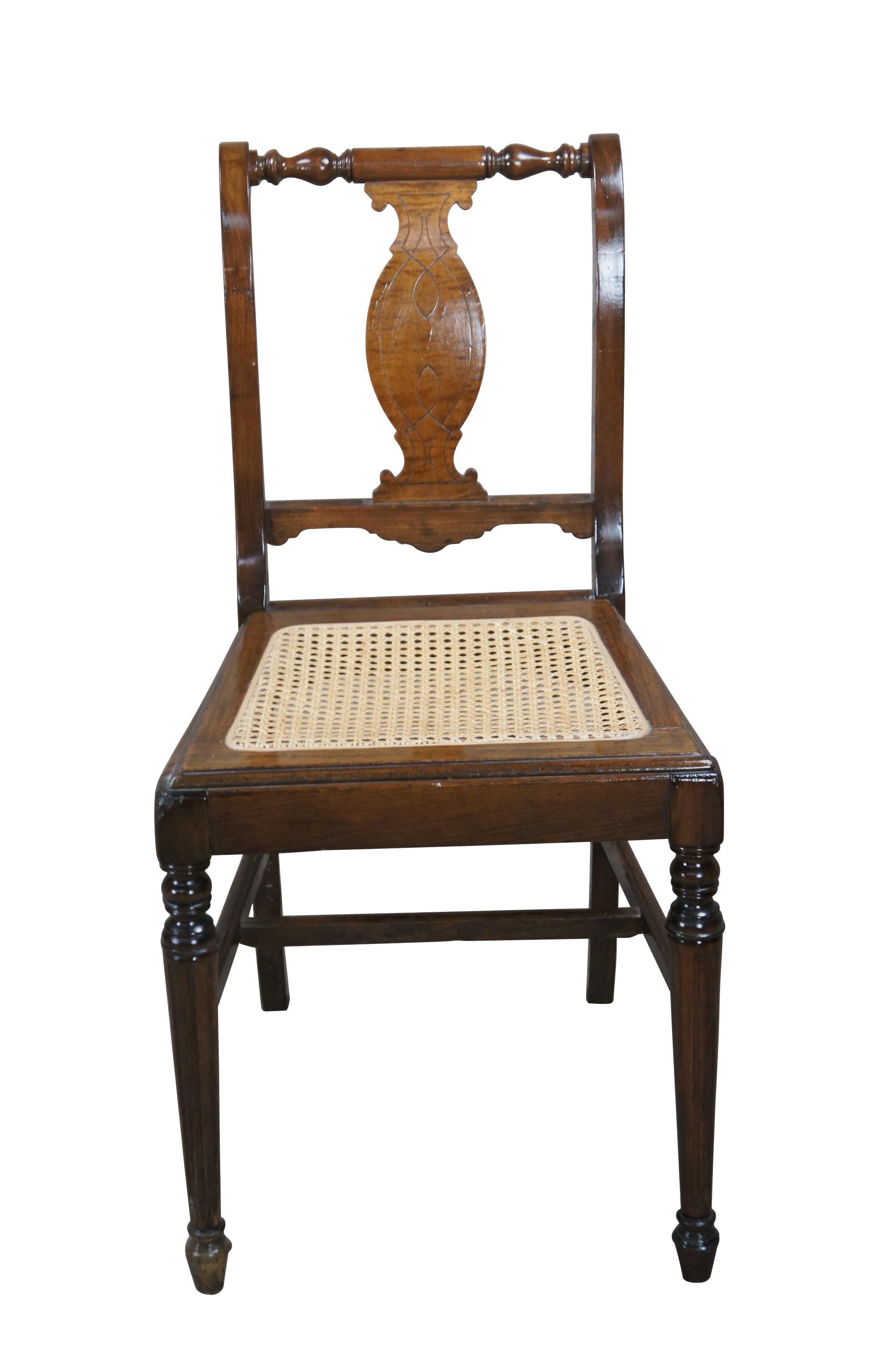 Antique Federal side chair.  Made from mahogany with curly mahogany back splat.  Features a scrolled form with turned crest rail and cane seat.  Front turned legs are connected to the rear square tapered legs by an H stretcher.  Front feet are arrow