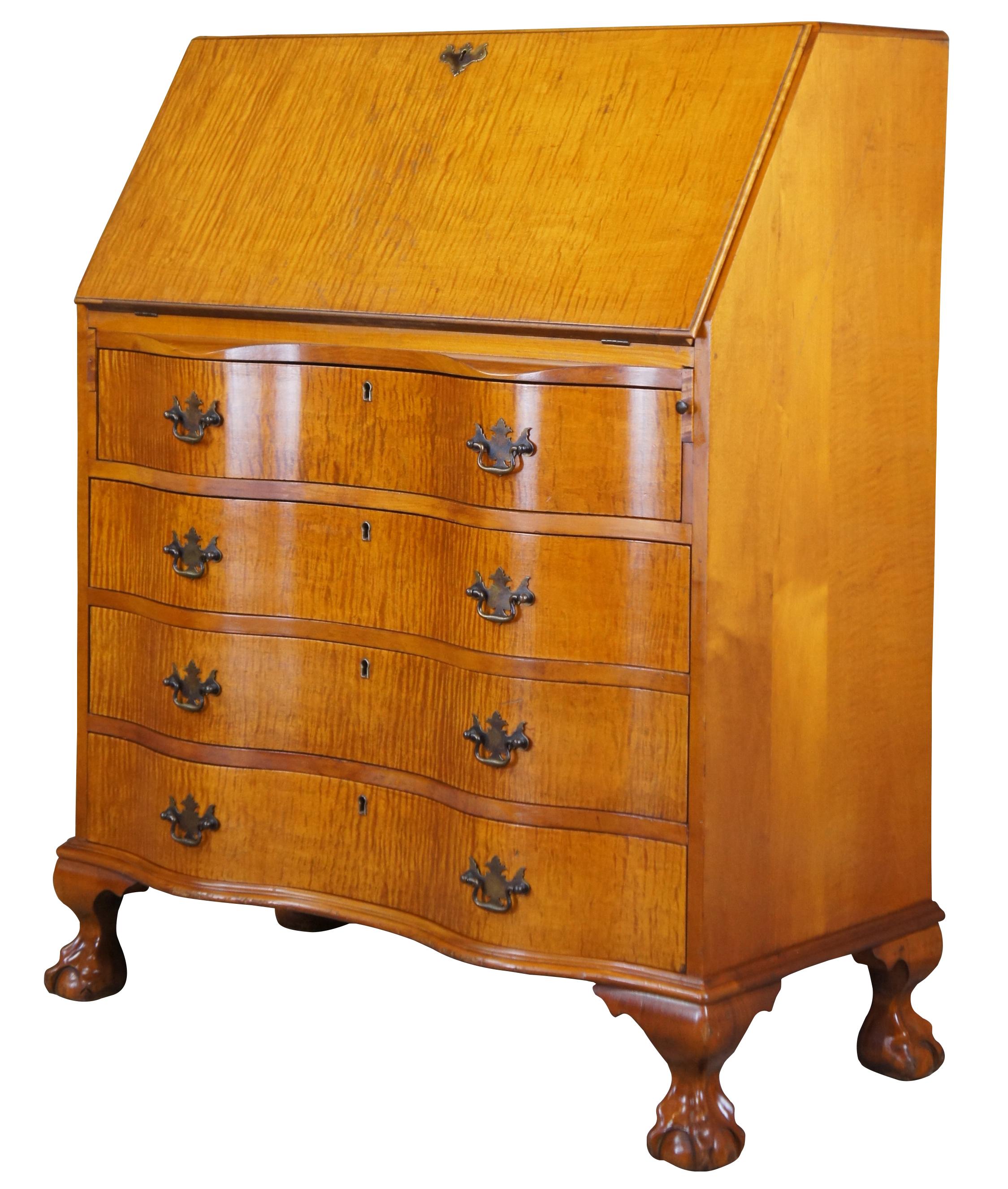 Antique secretary or writing desk. Made from tiger maple featuring a flip top that opens to multiple drawers, file storage and hidden compartments. The dresser is constructed with an oxbow front with four drawers and federal style hardware over ball