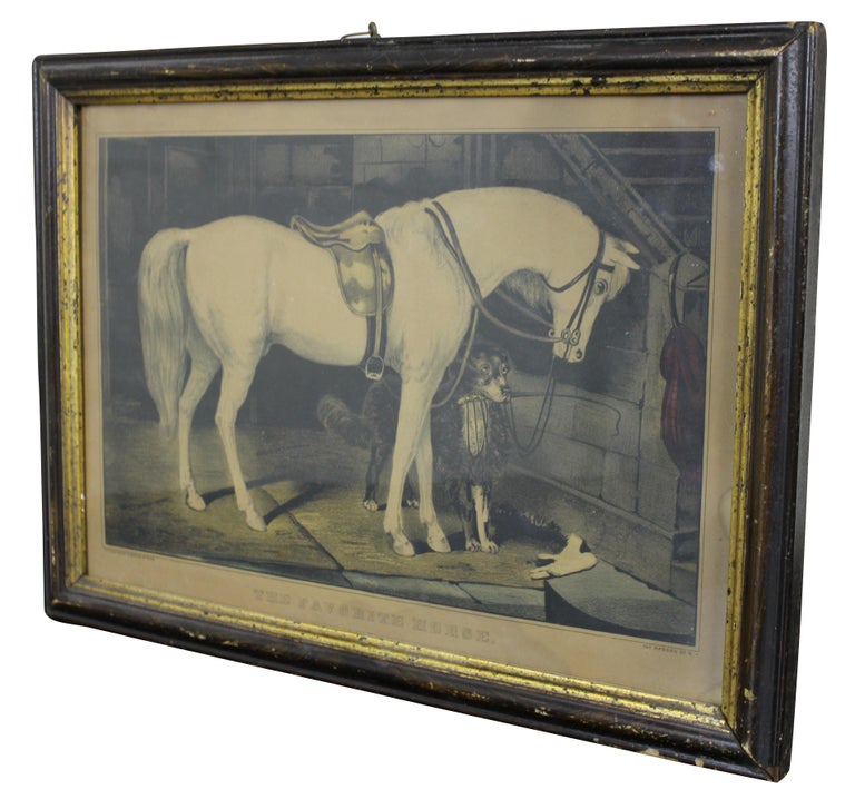 Antique lithograph print by Currier and Ives titled “The Favorite Horse” showing a white horse saddled in a stall with a border collie holding a riding crop in its mouth.

Measures: 15.5” x 1” x 11.75” / Sans Frame- 13.5” x 9.5” (Width x Depth x