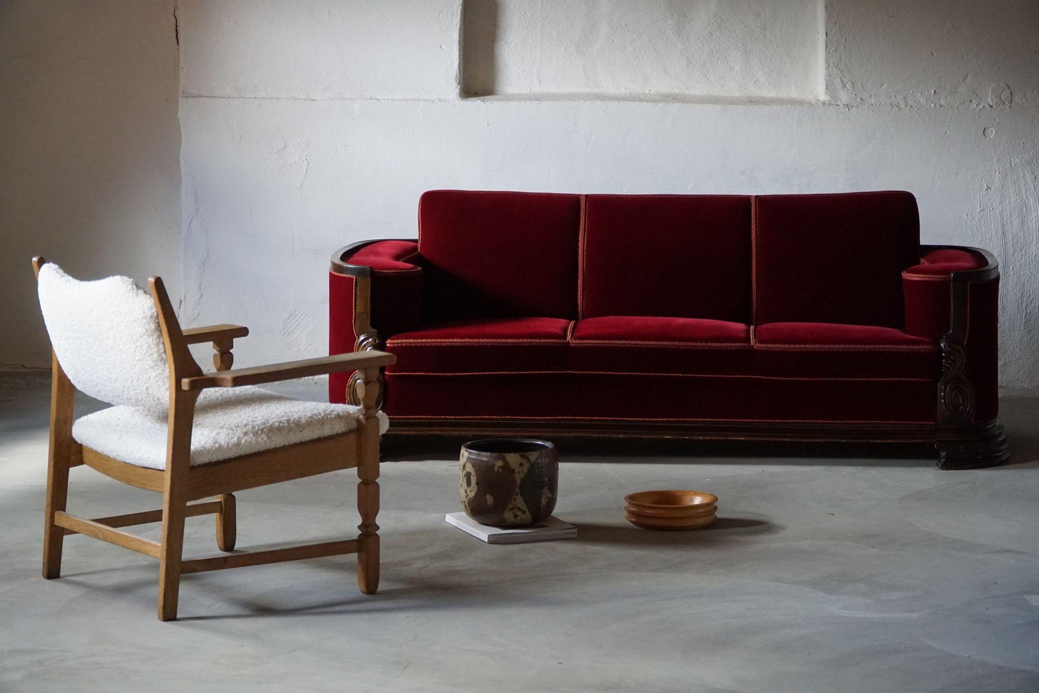 Such an elegant three seater antique empire sofa in a classic red velvet. Made by a Danish cabinetmaker in the early 19th century. The general impression of this vintage object is good. 

Beautiful curves that will complement many kinds of