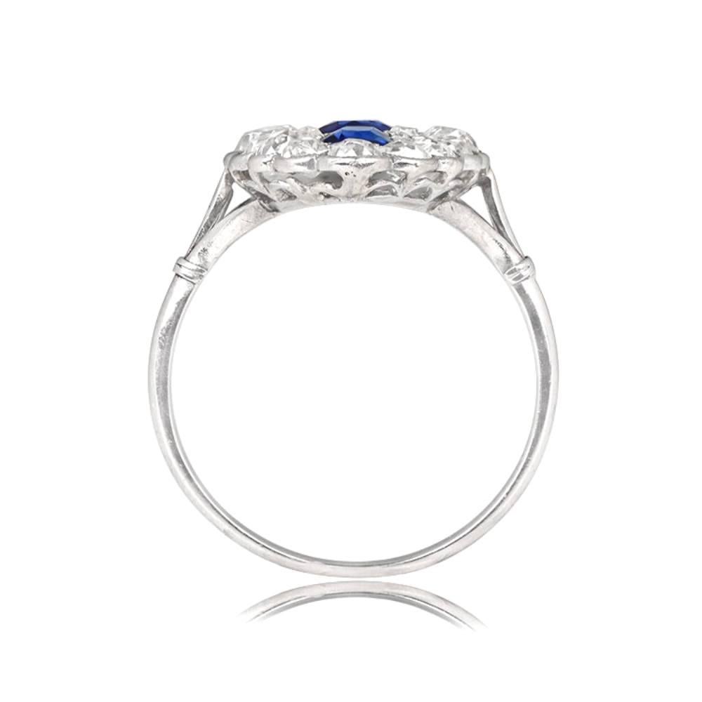 This is an antique Edwardian navette ring, handcrafted in platinum circa 1910. It features three natural sapphires weighing approximately 1.00 carat in total, with the center stone being round and the other two cushion cuts. The sapphires are framed