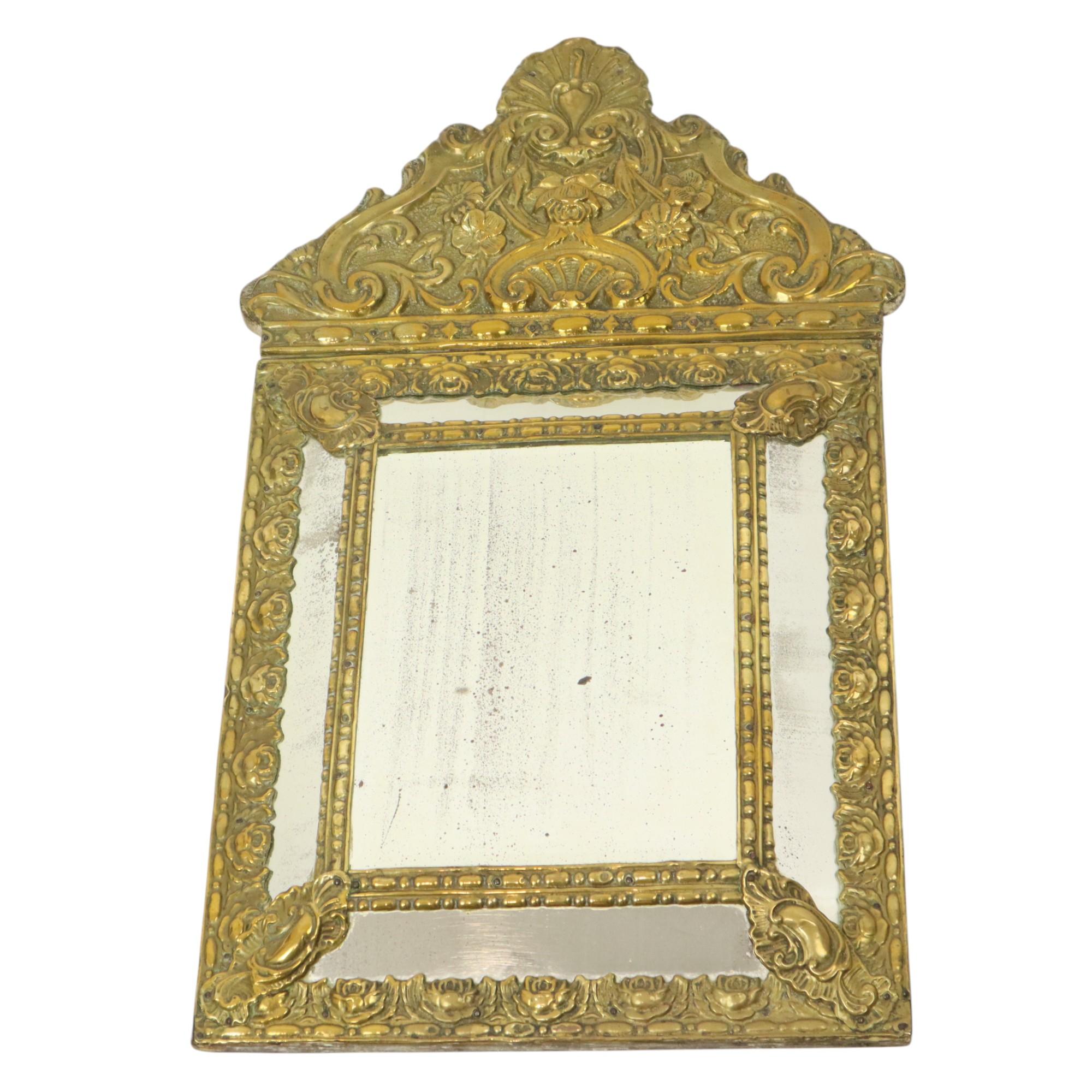 Fantastic antique cushion mirror, also known as a repousse mirror, facet-cut mirror from the latter part of the 19th century, circa 1880, also called the Belle Epoque period, France.

The central facet-cut mirror has 4 panels all around in relief,