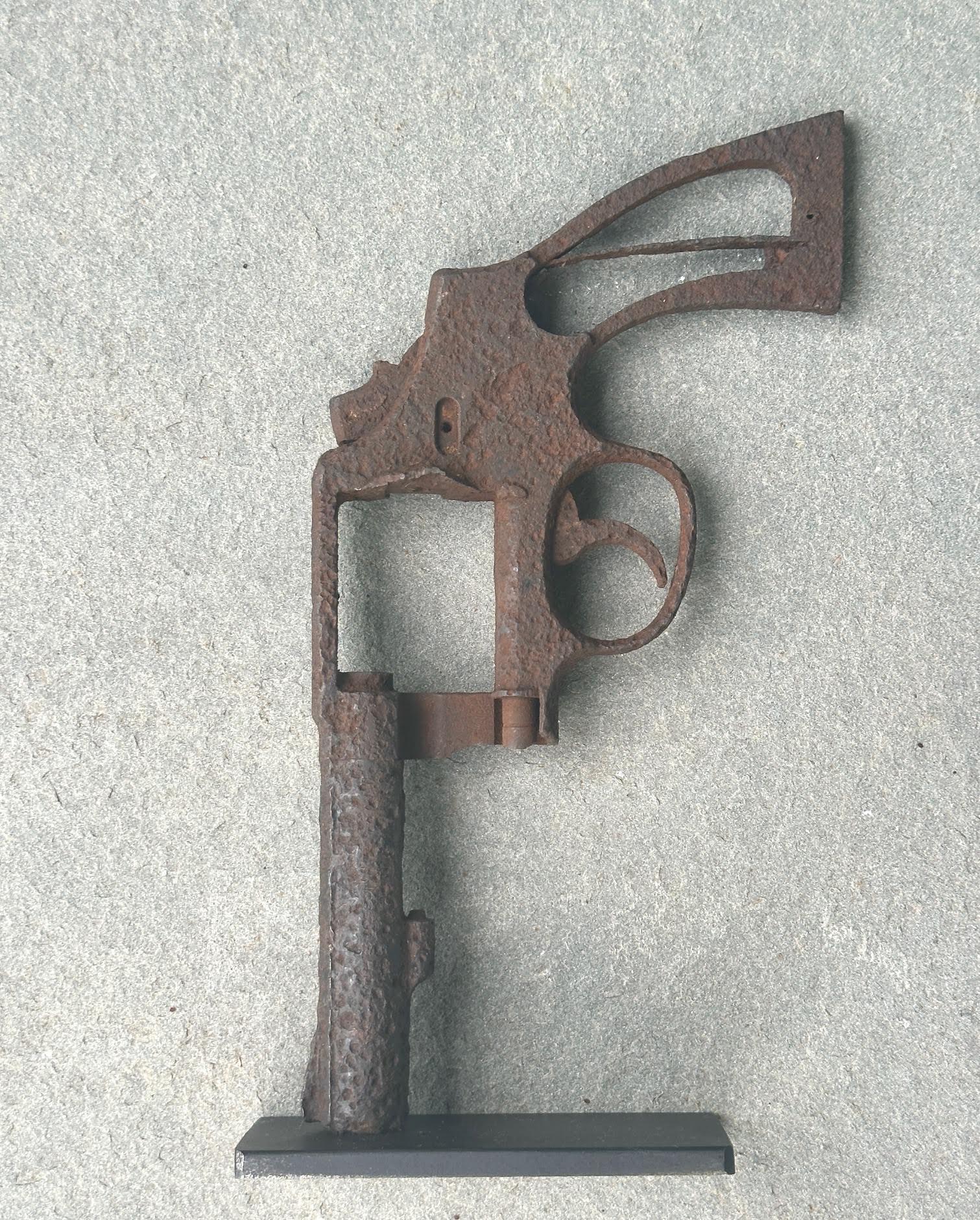 An antique circa 1940's-1950s Police model Colt 38 pistol frame. Custom mounted on a steel stand. Shows heavy pitting which adds to its character. 