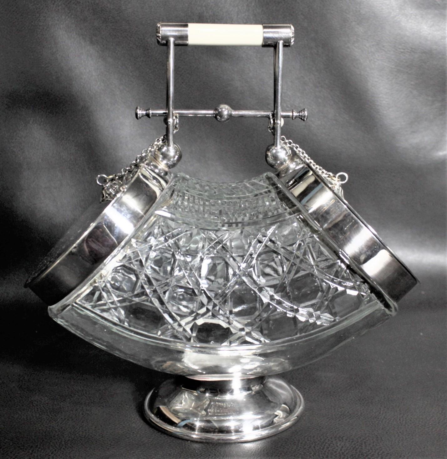 This very unique and impressive silver plated and cut crystal biscuit barrel was made by the Roberts & Dore Ltd. shop in London England in circa 1910 in the period Edwardian style. This biscuit barrel is quire rare in its design as it features a