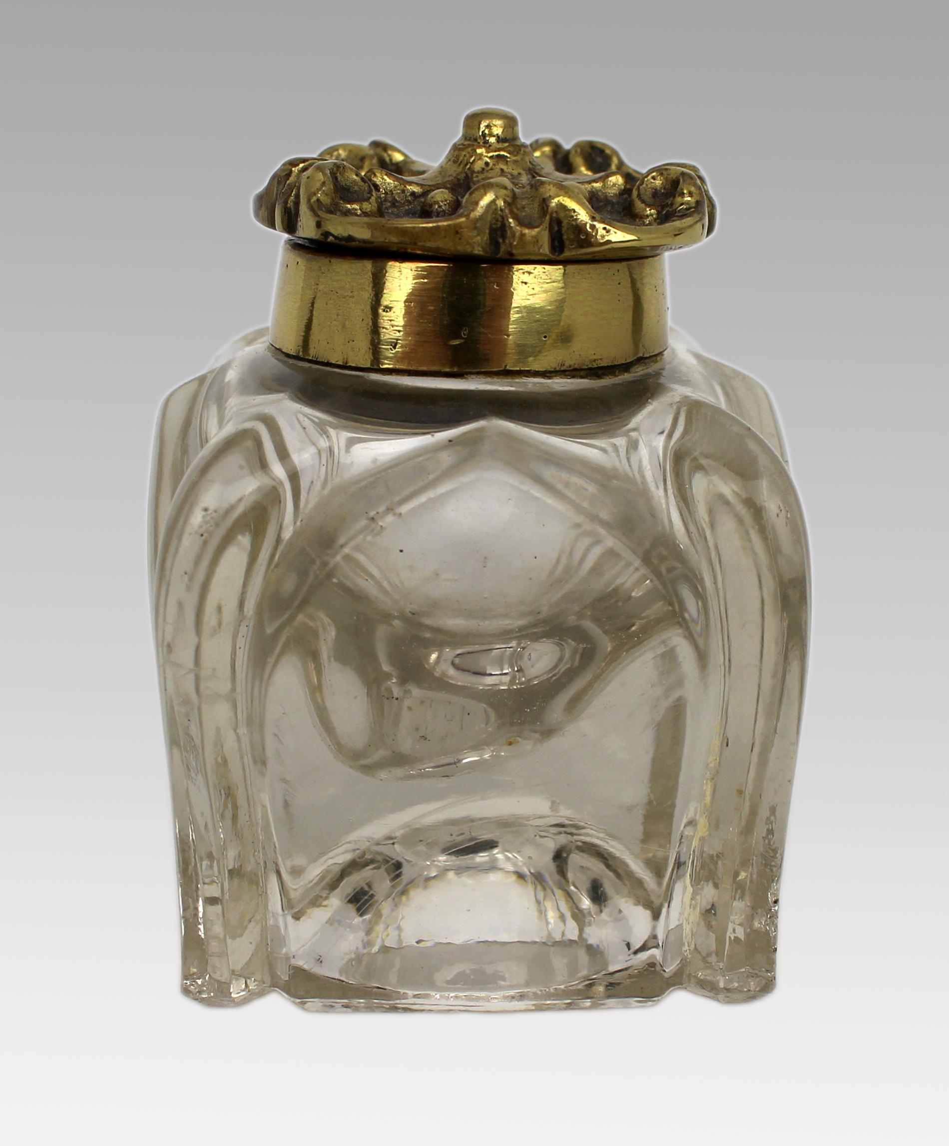 Antique Cut Glass and Brass Crown-Top Inkwell, Early 20th Century

England, circa 1900–1920

A decorative and well-crafted antique inkwell featuring a heavy moulded glass body with bold architectural form and an ornate crown-shaped hinged lid in