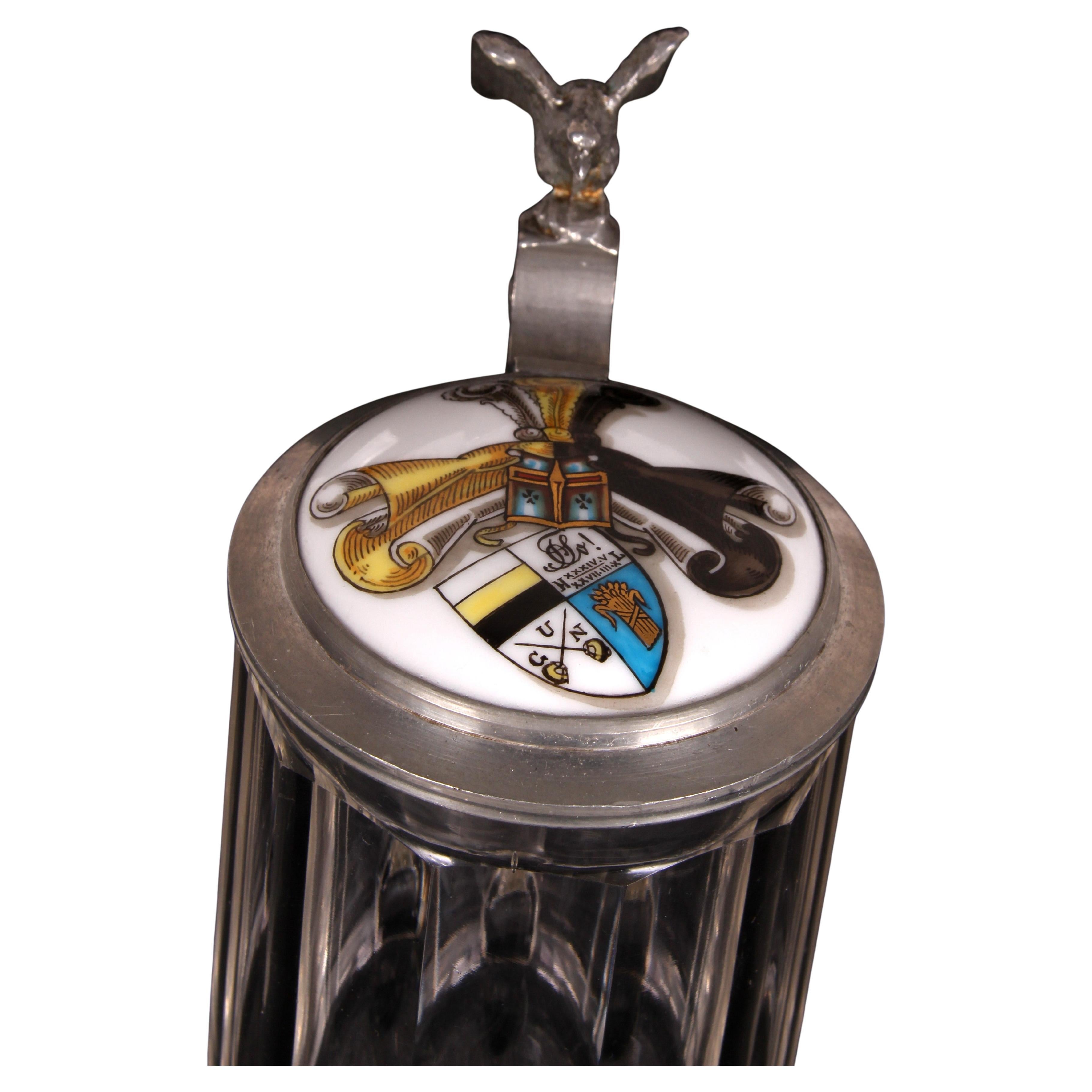 Antique glass beer jug with a pewter and porcelain lid
Hand painted by Ludwig Kannengießer
A commemorative gift from a university fraternity.

Southern Germany 1927 

Ø 7.5 cm ~ Height: 11,5 cm - with lid 15,5 cm ~ Weight 405 grs

Southern Germany
