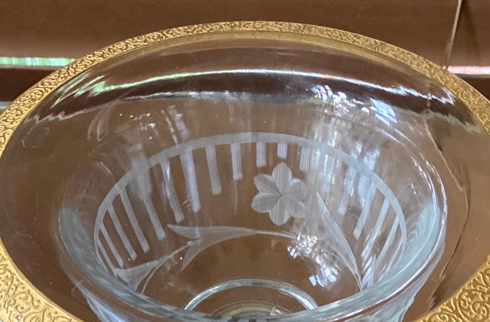 An antique chased gold encrusted console bowl made by Westmoreland in the 1910's-20's. Engraved florals and bars, or fencing, on the bowl. 

This is a lovely etched and cut footed 
bowl/compote with chased gold trim, perfect for your favorite table,