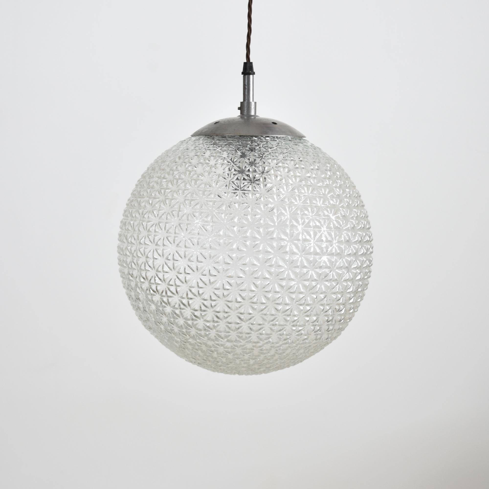 Czech antique glass pendant light large – B.

These unique glass pendants were salvaged from a school hall in former Czechoslovakia, featuring unique cross-cut diamond glass. The glass provides a striking even glow when illuminated. The light