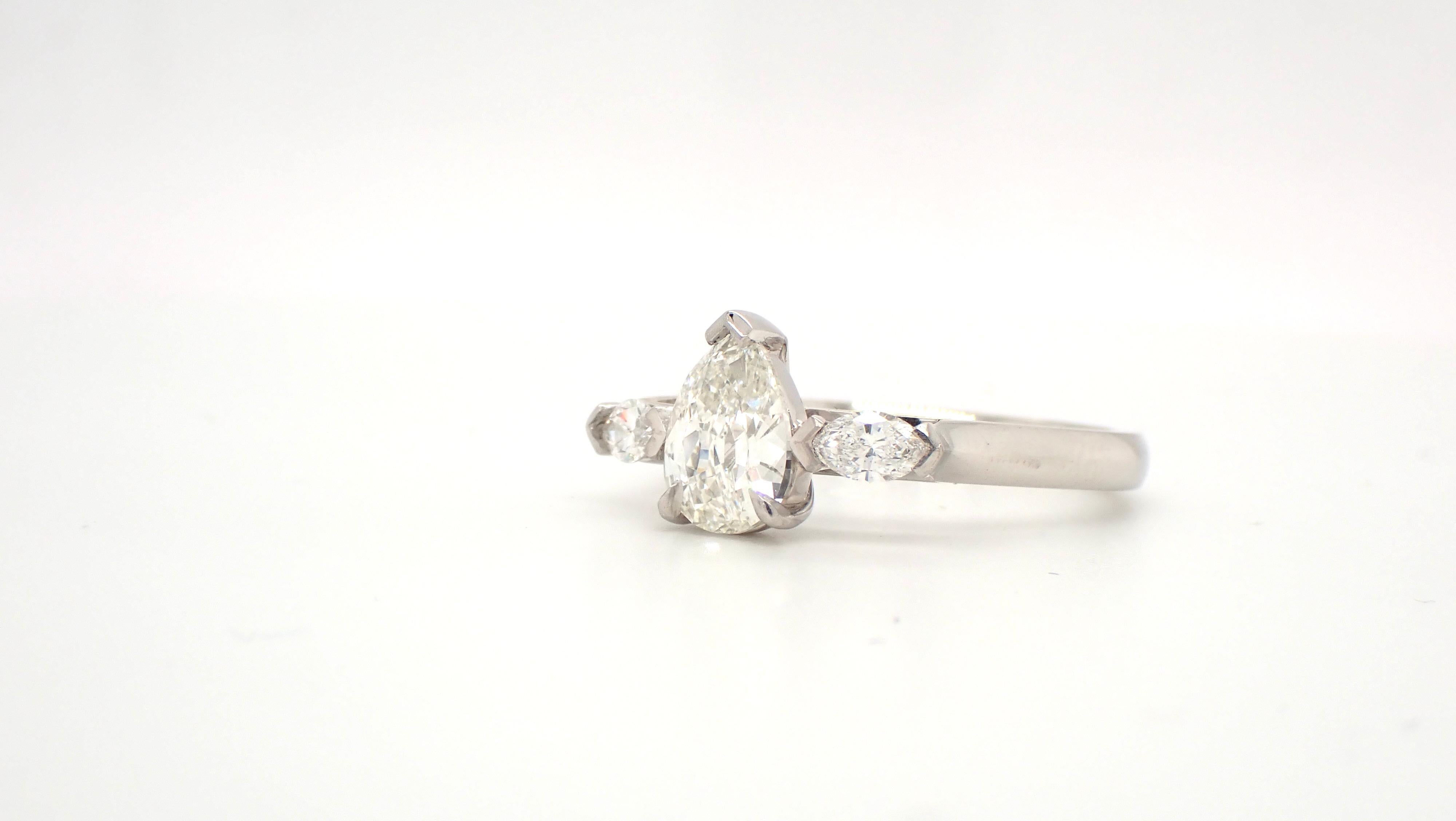 The allure of old cut diamonds is evident with this beautiful antique cut Pear Diamond Platinum Engagement Ring. The central 0.9 carat pear diamond has lovely facets which throw the light in such a different way which makes it evident to diamond