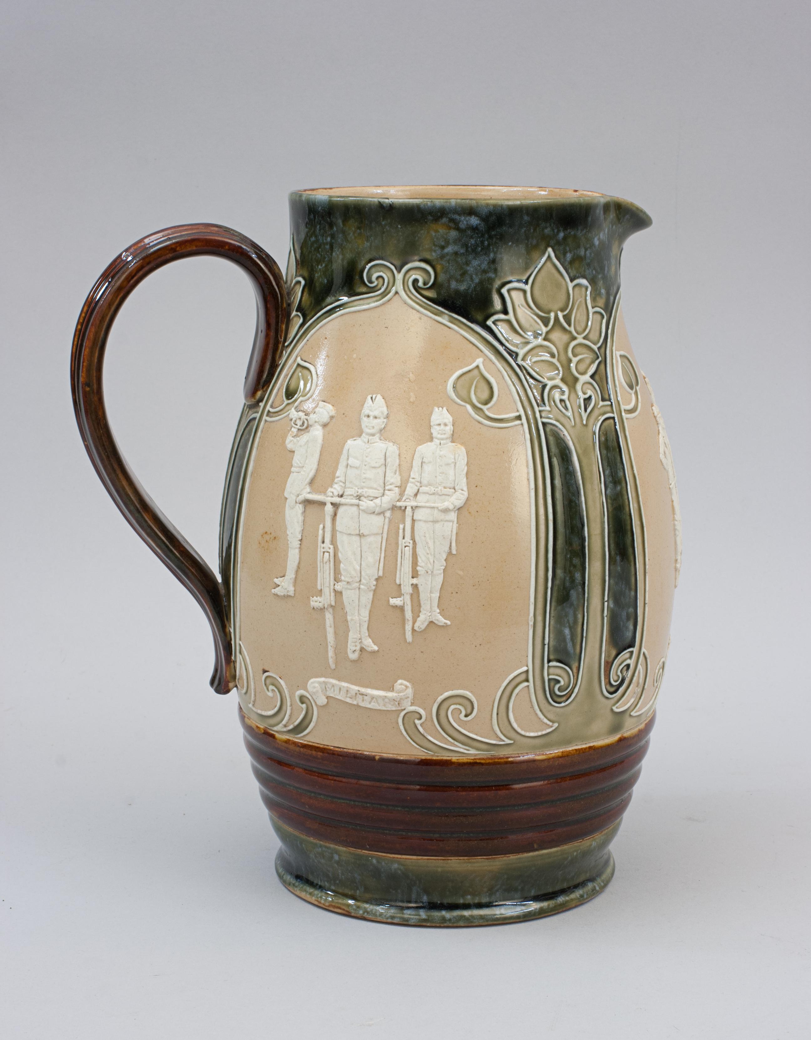 Royal Doulton Lambeth Ware Cycling Jug.
A rare Royal Doulton Lambeth stoneware jug with art nouveau design and three cycling scenes in white relief showing Men and Woman on bicycles originally designed by John Broad. The scenes are entitled: