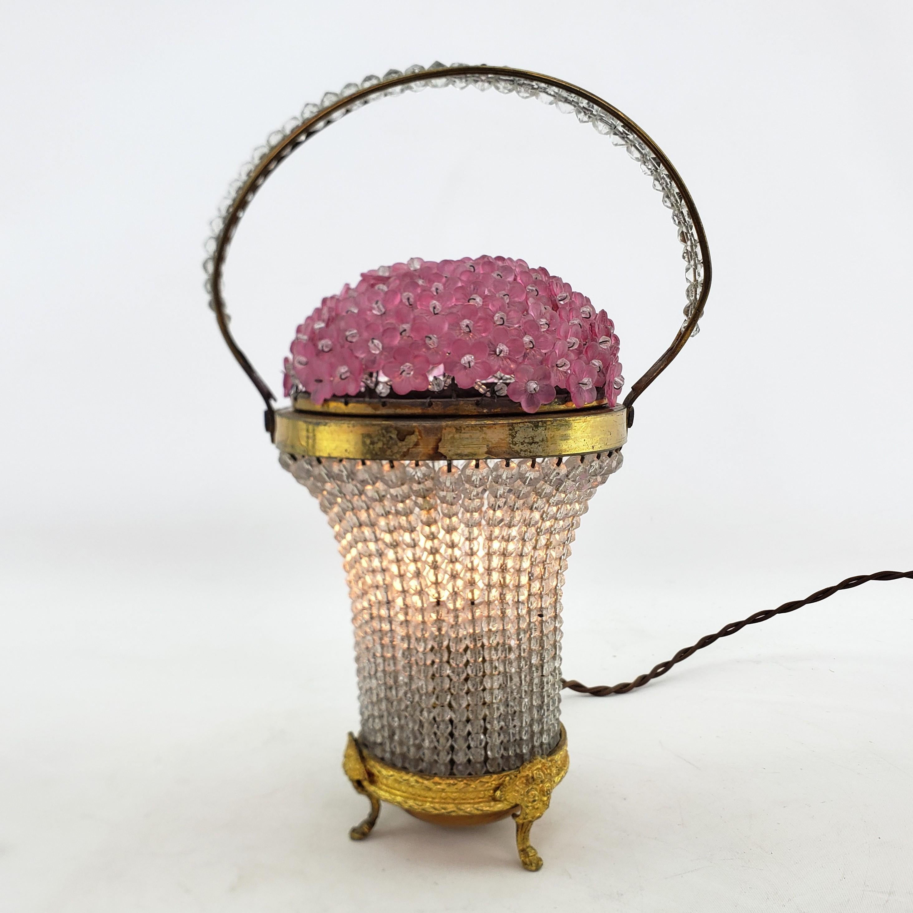 This vintage accent table light is unsigned with respect to the maker, but presumed to have originated from the Czech Republic and date to approximately 1920 and done in the period Art Deco style. The light is composed of a thick wire frame with a