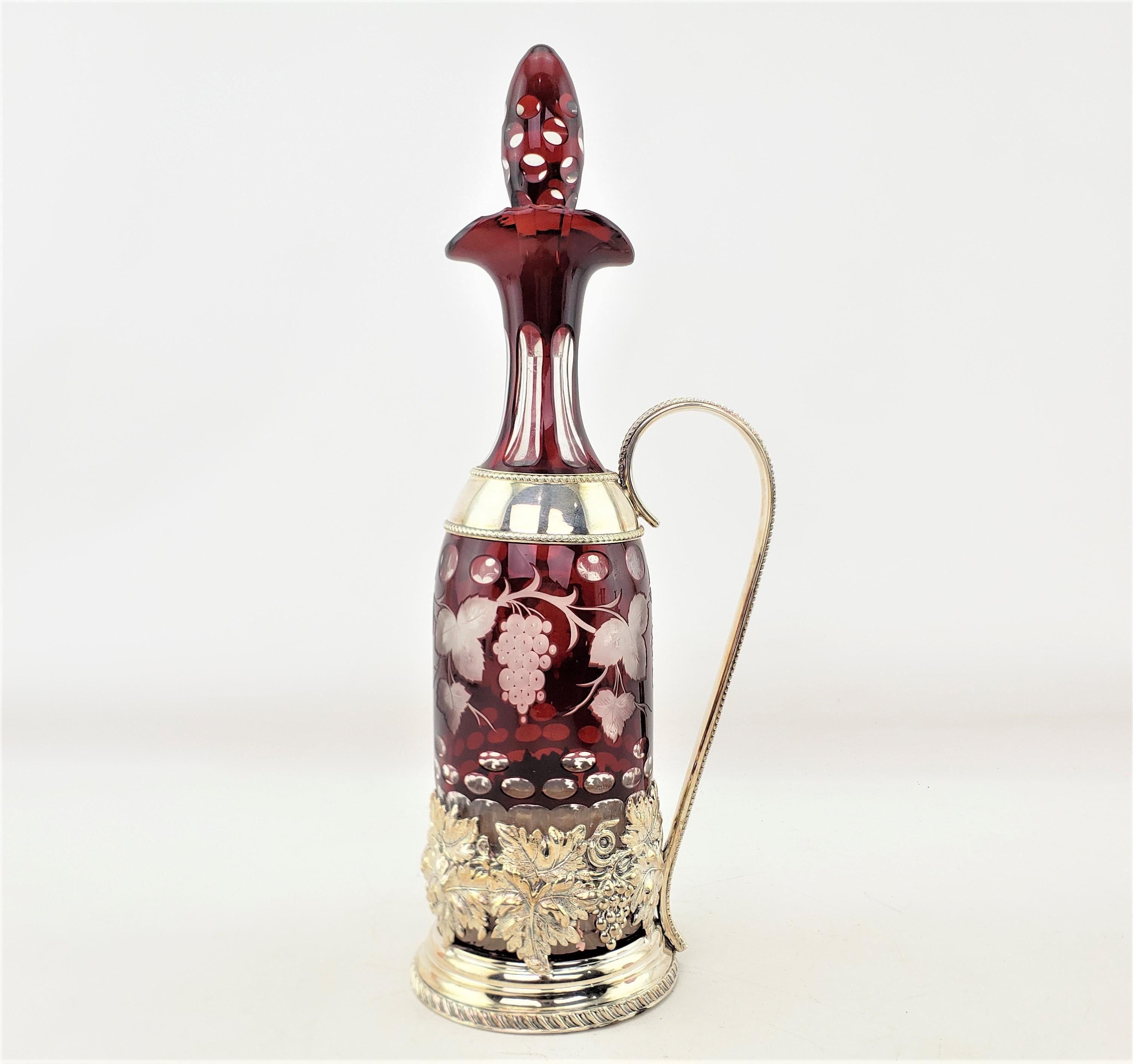 This antique decanter stand is signed by an unknown maker, but believed to have originated from the United States and date to approxiately 1900. The decanter bottle is presumed to have originated from Bohemia, now the Czech Republic and dating to