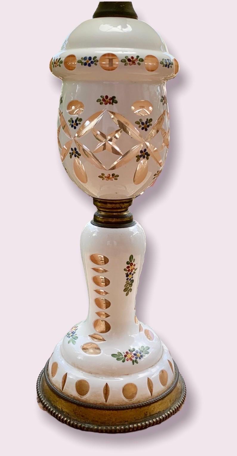 A stunning cased glass white over amber table lamp with hand cut ovals & hand painted flowers, oval cuts around the bottom and hand cuts all over.
A lovely addition to your dressing table, bedroom, dressing room or an entry.