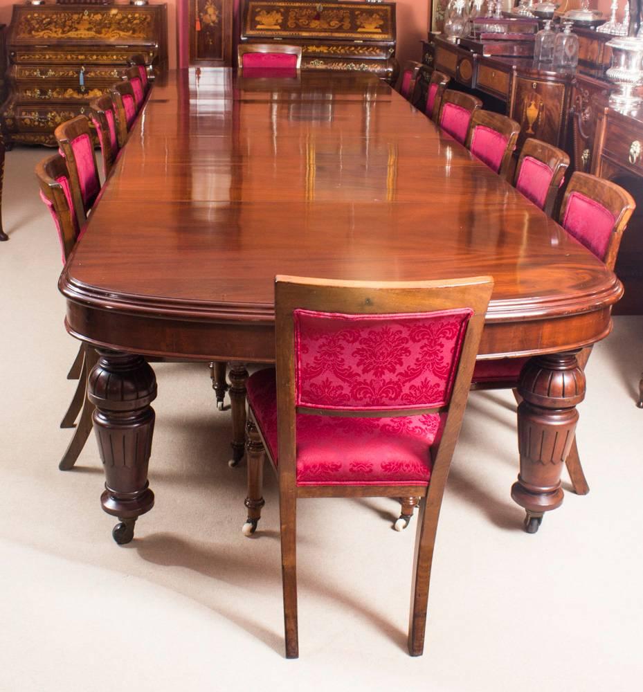 This is a fantastic dining set comprising of an antique Victorian solid mahogany D-end dining table with an antique set of fourteen dining chairs, all circa 1870 in date.

The beautiful table is in stunning flame mahogany and has five leaves of