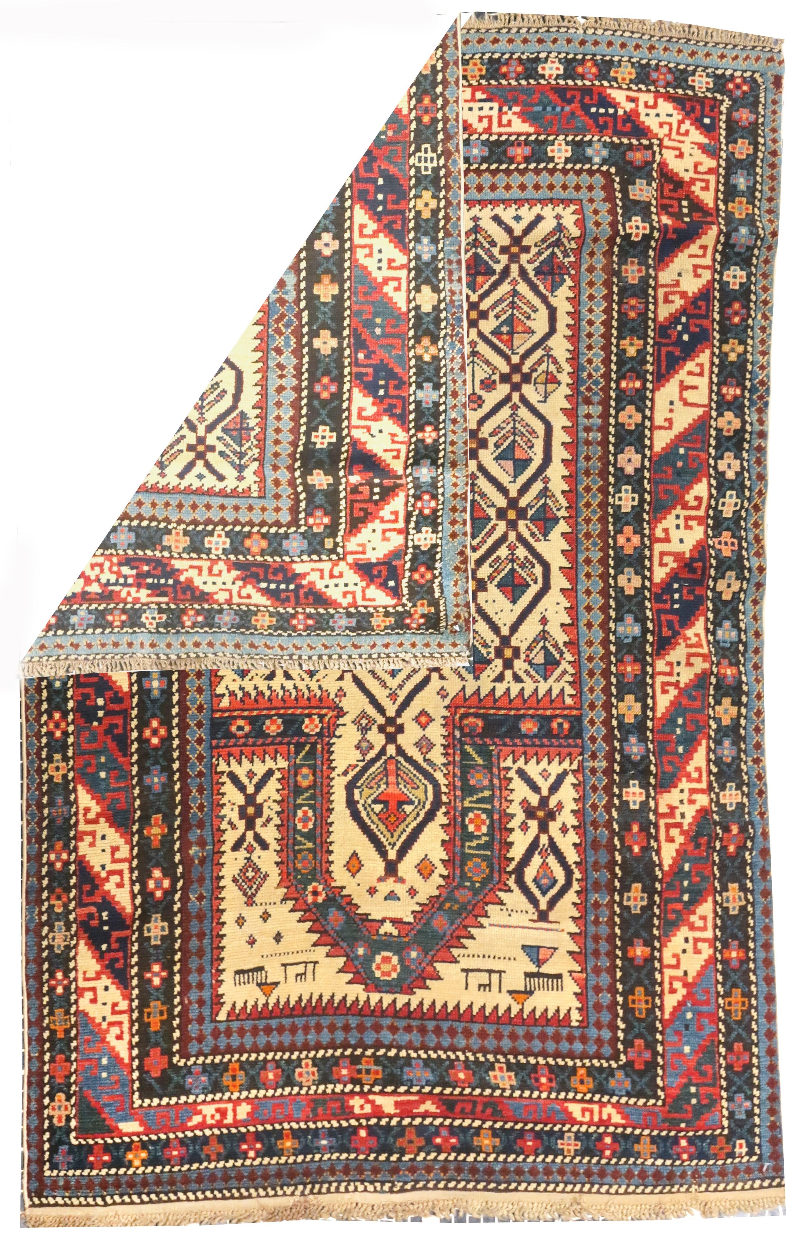 Antique Daghestan Shirvan rug 3'4'' x 5'2''. The narrow ecru field displays a lozenge lattice enclosing a one-way floral pattern, with animals in the spandrels. Serrated niche arch and field edging. The main border shows geometric slanted