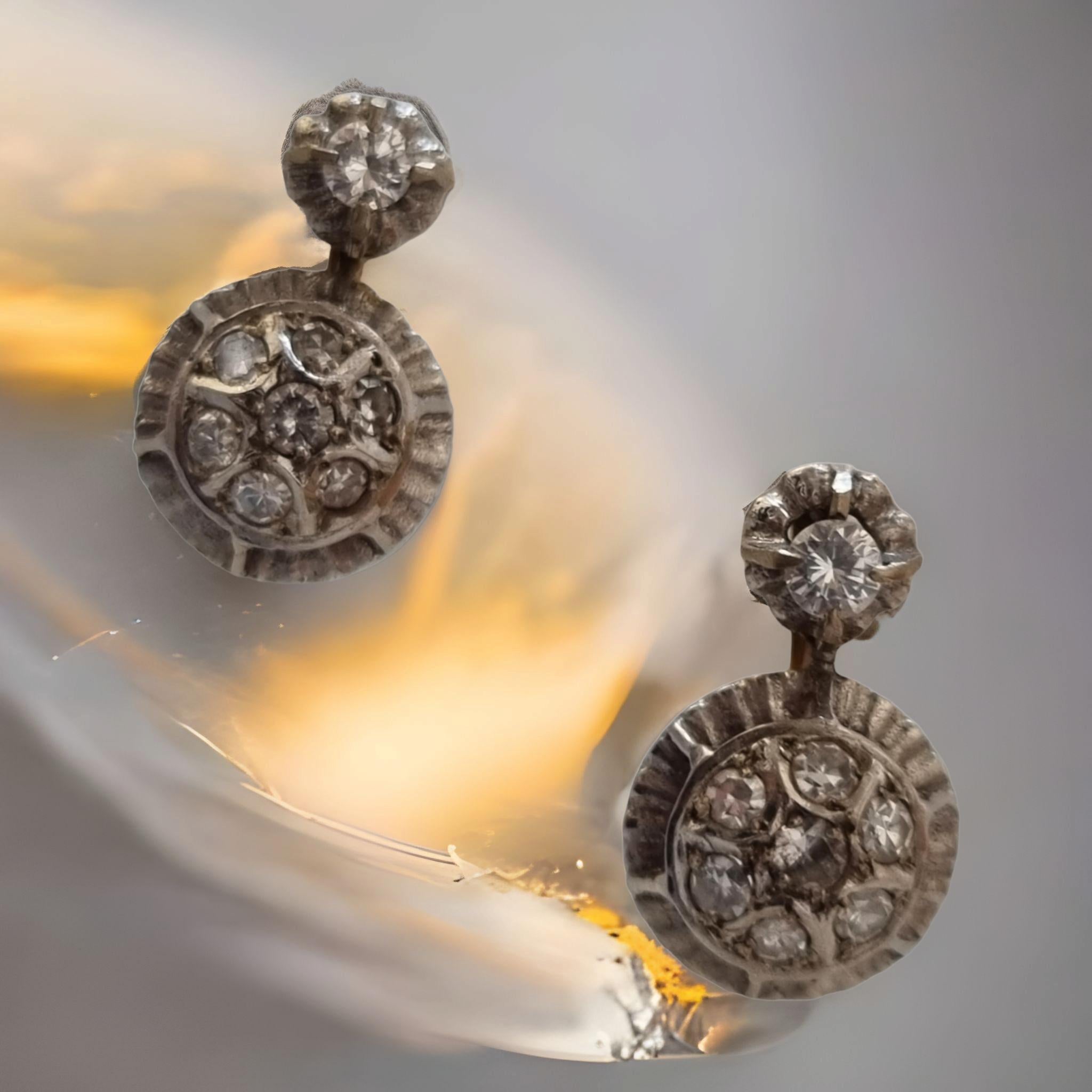 ANTIQUE SPANISH DANGLE CLUSTER DIAMOND EARRINGS (Circa 1901-1915)
Edwardian Jewelry: 1901-1915
A central disc cluster of bright-white old European-cut diamonds floats inside--and slightly above-- a ring of the same, all of which dazzle and dance