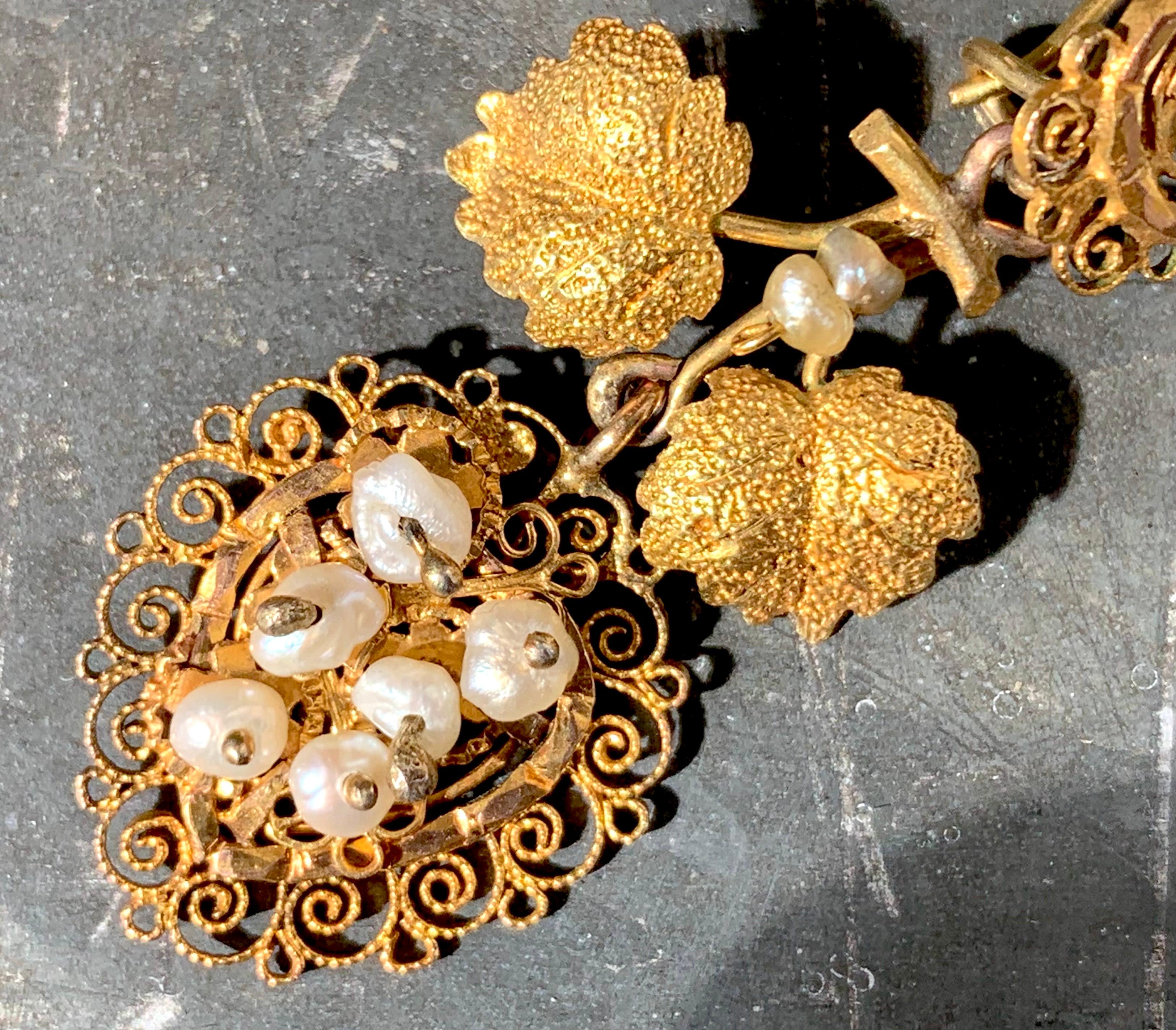 These delightful earrings designed as grapes in heart shape hanging from vine. The vine leaves, cut out of engraved and embossed gold have been handcrafted in Italy in the 1870's.  