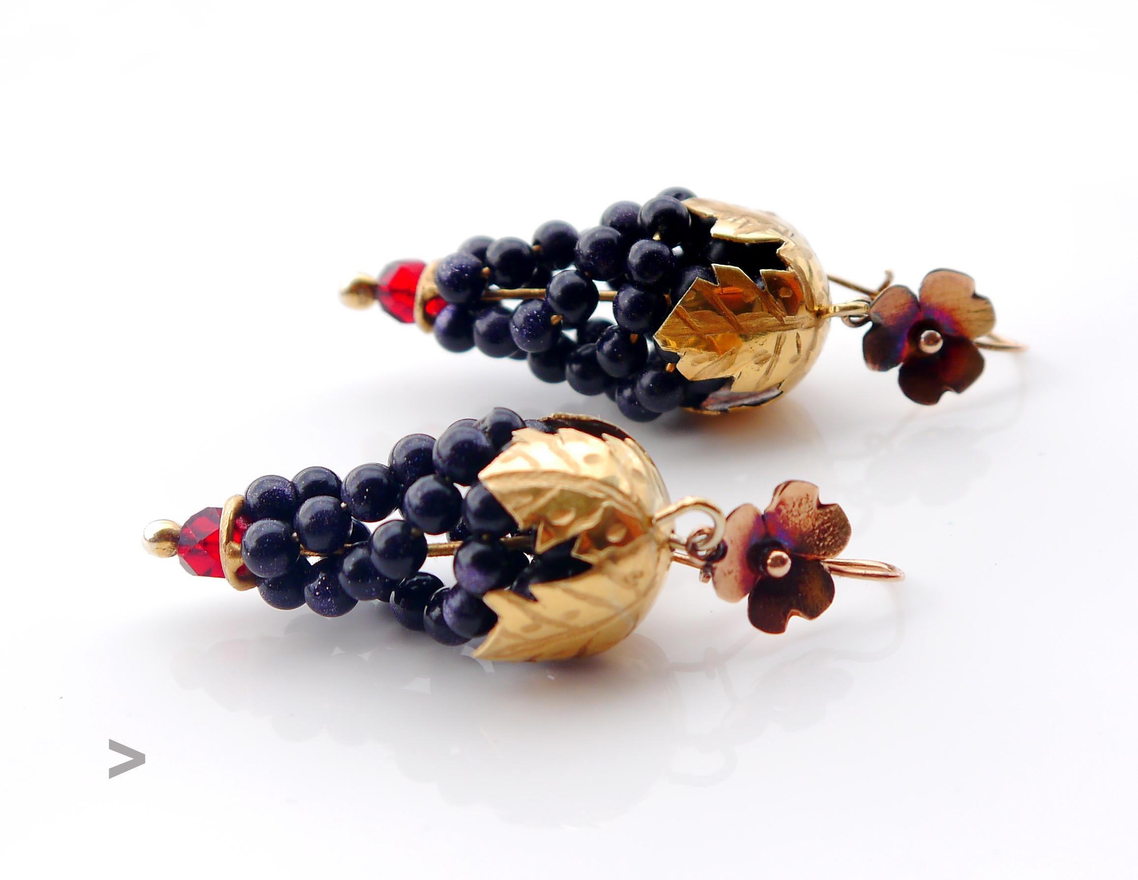Old European Earrings with all metal parts in solid 14 Gold and Paste Glass successfully imitating a couple of Grape clusters in shapes and colors.

Multiple dark Blue orbs dotted with fused shiny metallic particles look very much like Lapis Lazuli,