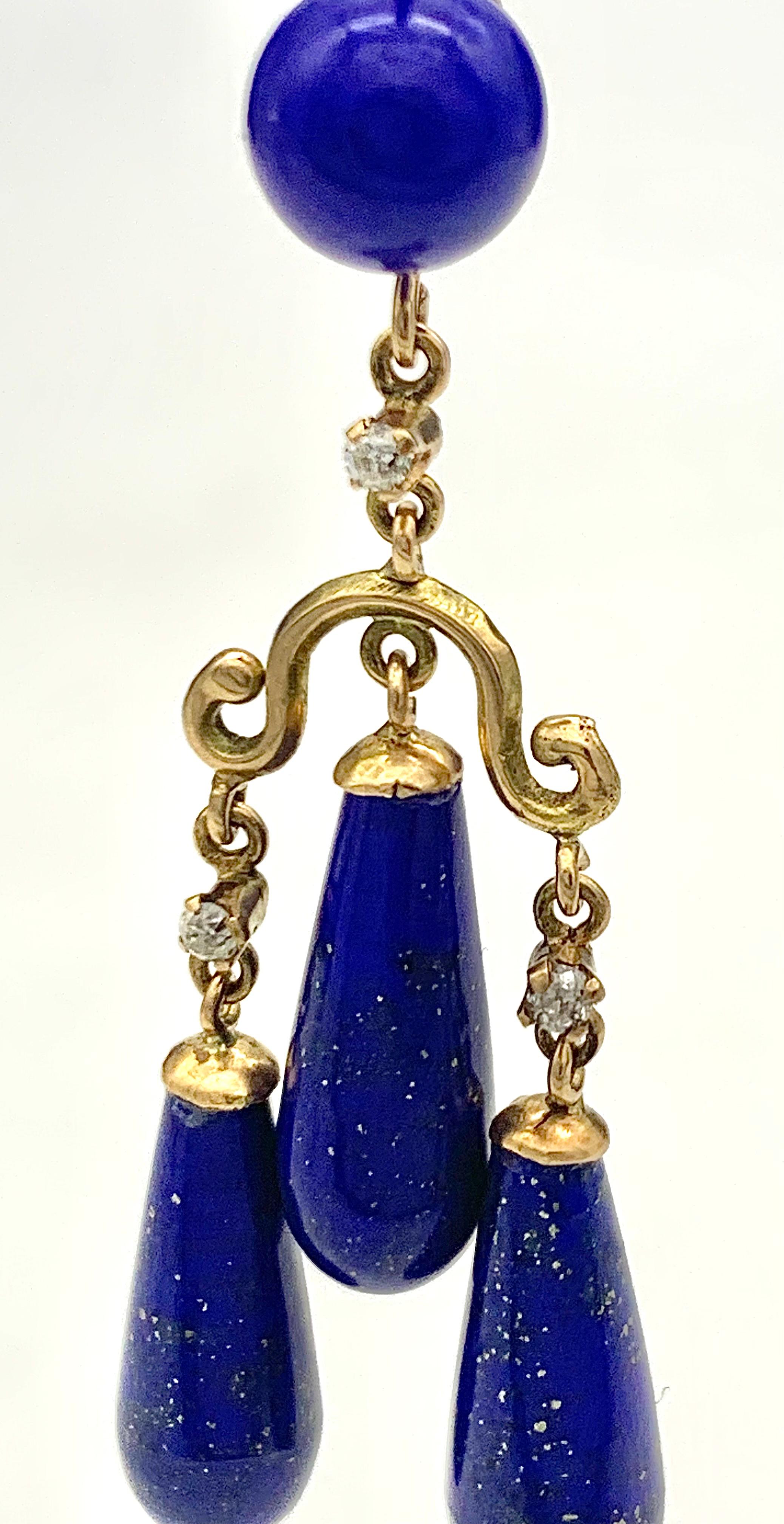These elegant dangling earrings were made out of 14 karat gold in 1870 ca. The earrings are in designed in Greek revival taste. The earrings consists of tops set with a lapis lazuli bead with  hooks that come with a safety device. From a short