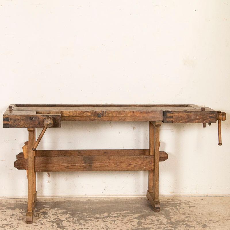 This rustic 5.5' carpenters’ workbench reveals a rich patina after years of traditional use. Please examine the close up photos to appreciate the depth of the patina and notice the dings, scrapes and even residual old paint that reflects how it was