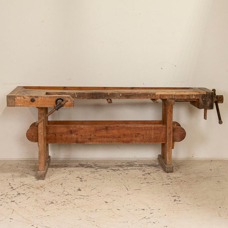 It is the years of constant use revealed in every ding and scratch that enrich the character of this delightful carpenters' workbench from Denmark. Please examine the close up photos to appreciate the patina, joints and old hardware. It has two