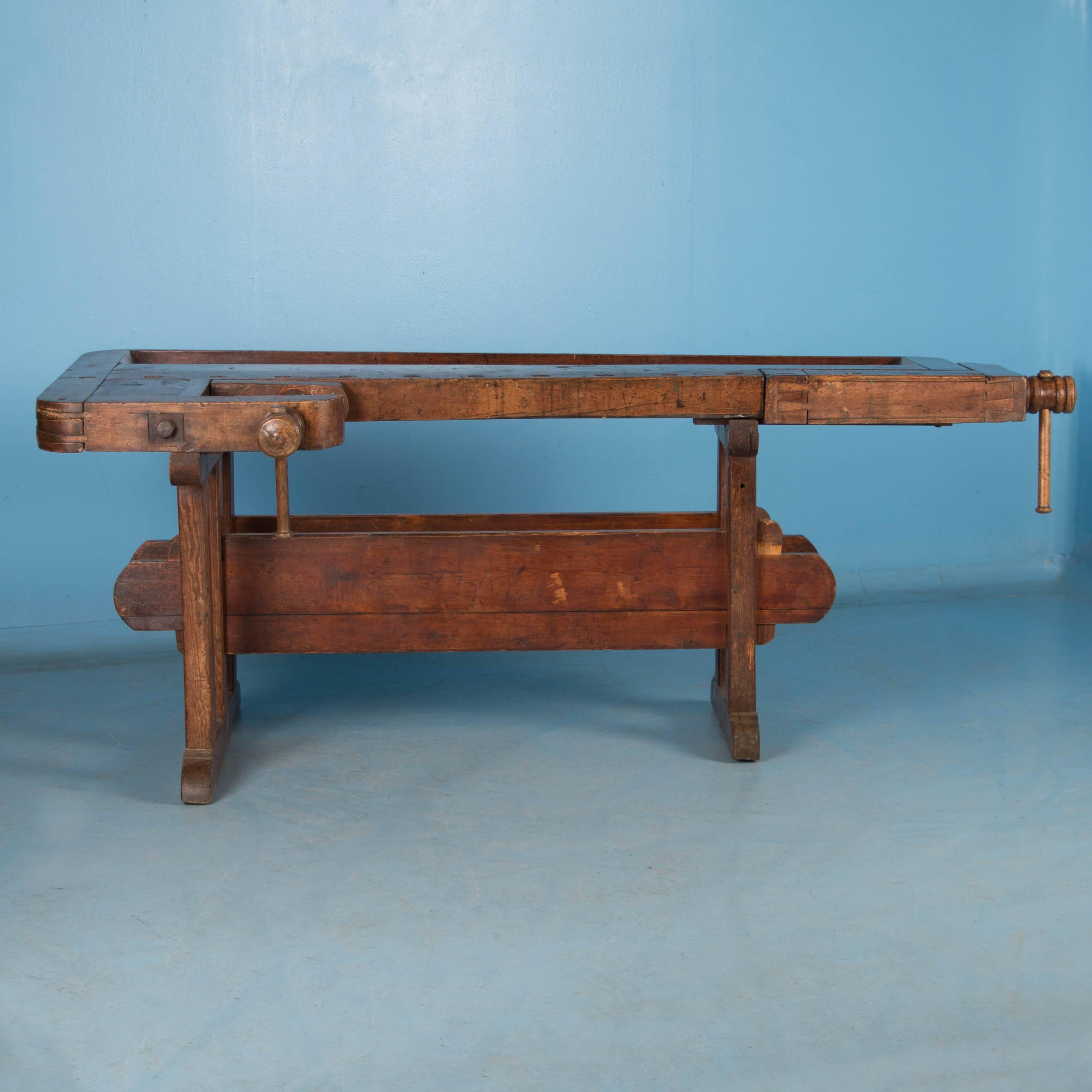 Beautiful antique Danish carpenters' workbench, bearing an incredible patina after years of traditional use. Please examine the close up photos to appreciate the depth of the patina. It has two wooden vices with wood handle and a recessed tray where