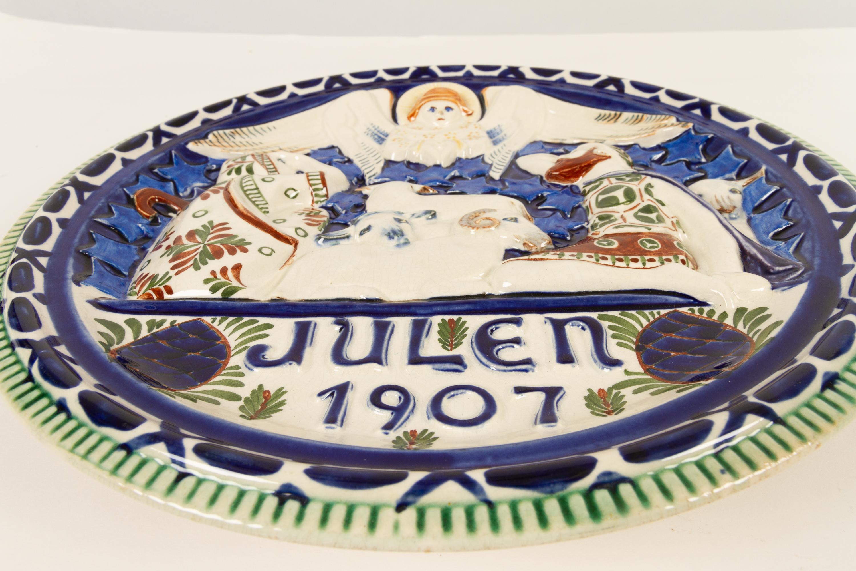 Antique Danish Christmas Porcelain decorative plate by Aluminia 1907.
Large Christmas plate by Aluminia ( later Royal Copenhagen ) in hand painted faience. The word 
