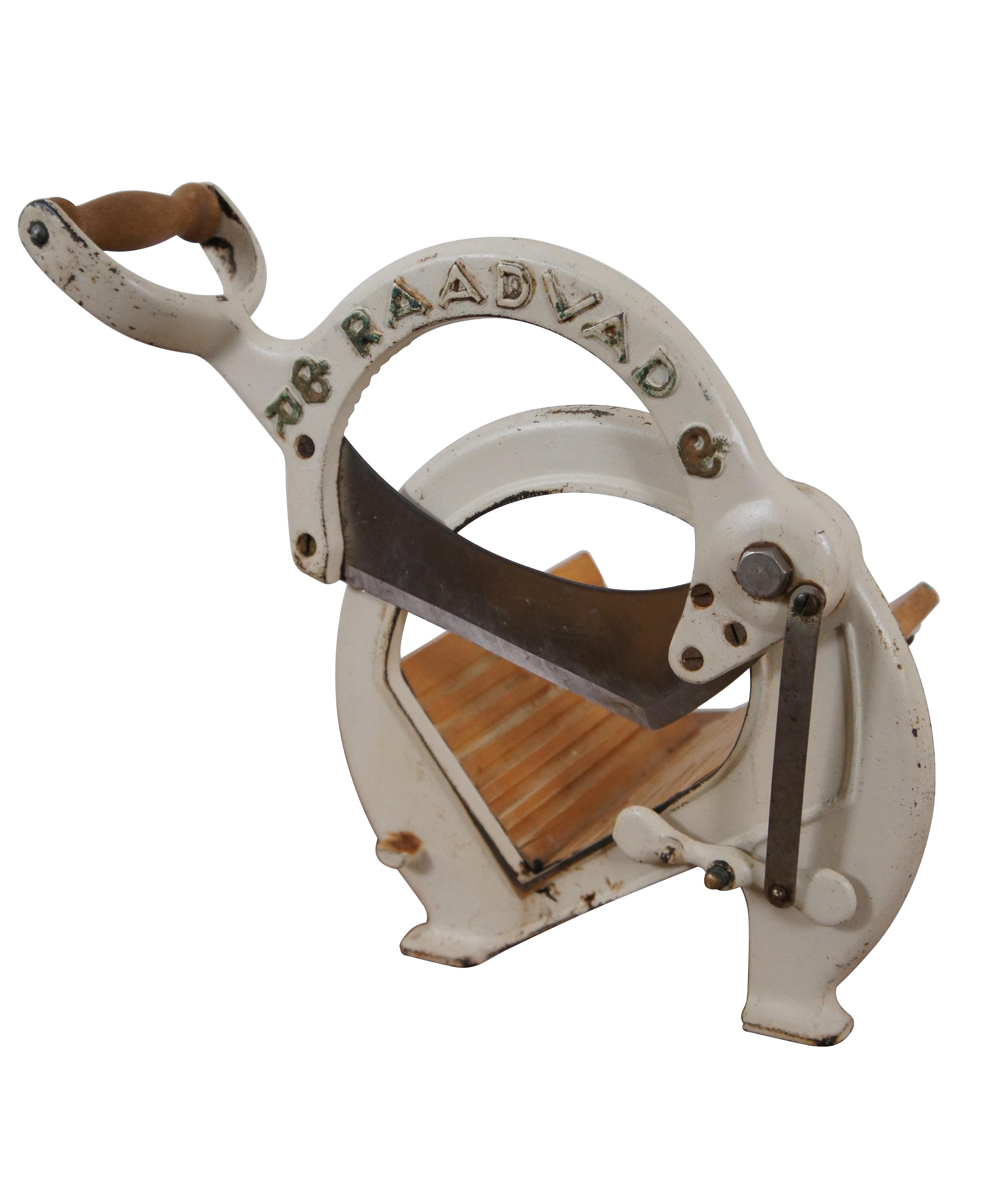 Mid to early 20th century off-white painted wood and iron bread slicer produced by Danish company Raadvad. Designed by Ove Larsen in the 1930's and produced from the 1940s-1970s.

