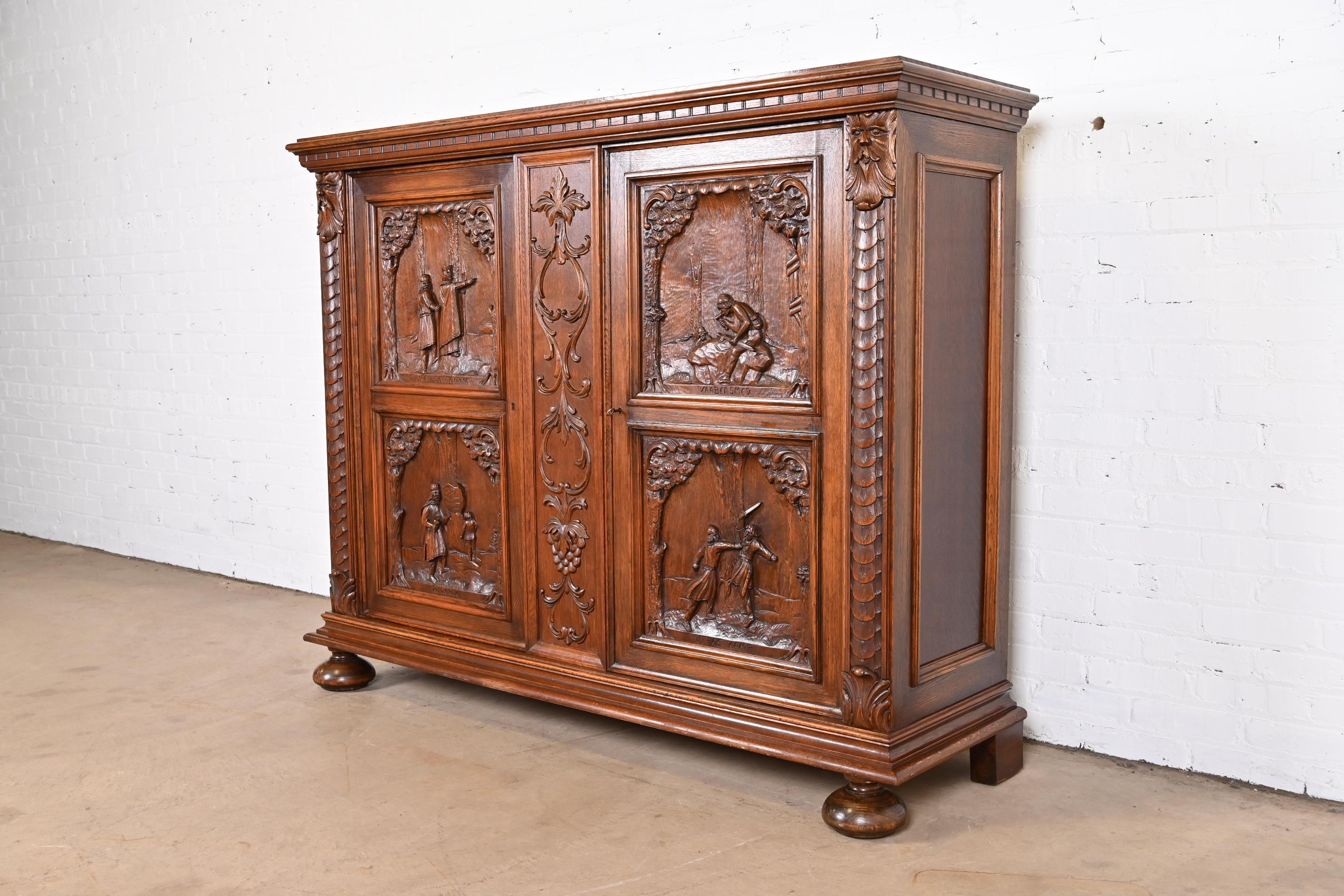 A gorgeous antique Scandinavian Renaissance Revival sideboard or bar cabinet.

Denmark, circa late 19th century

Ornate carved oak, with panels depicting various scenes, Old Man of the North carved faces, and the case raised on bun feet. Cabinet