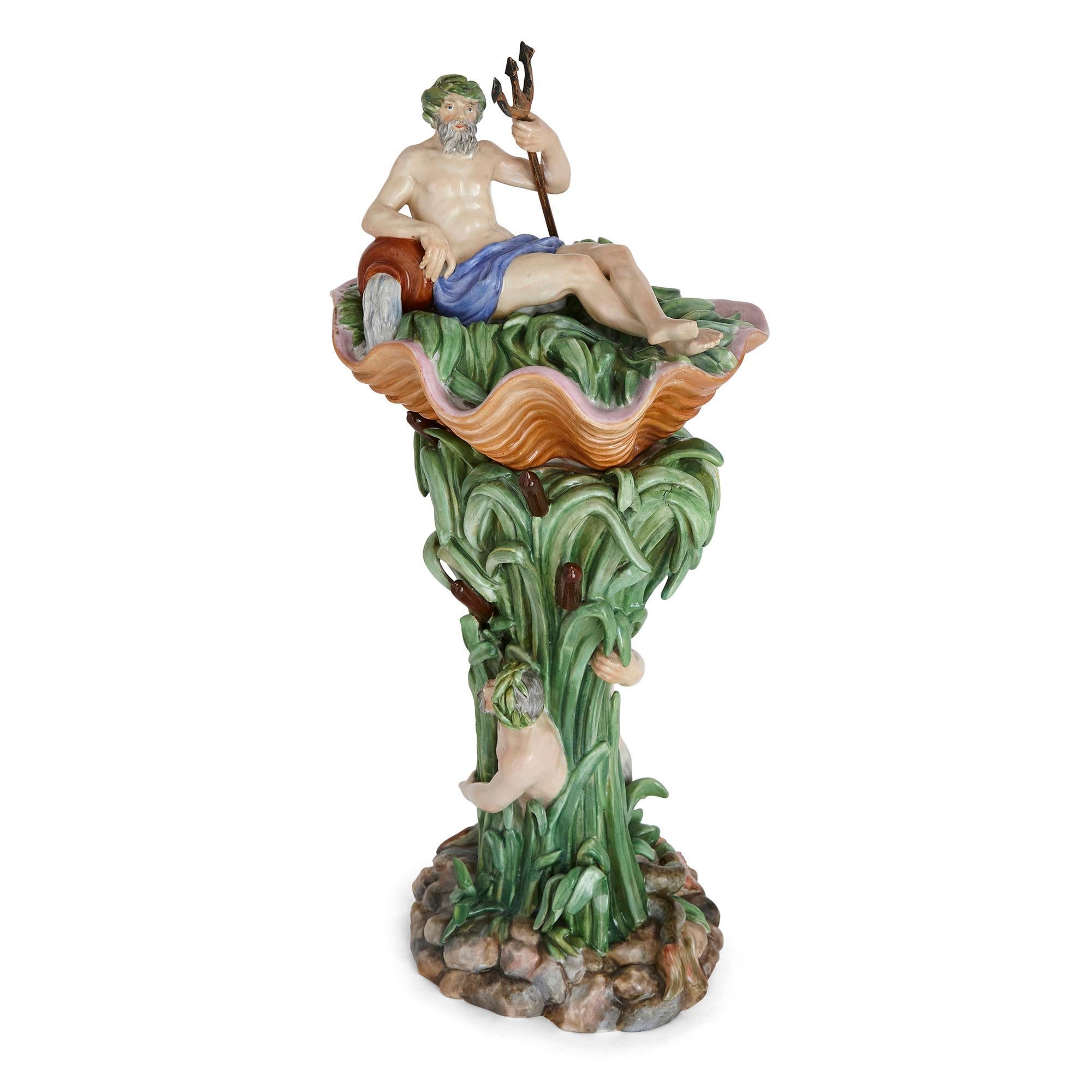 Antique Danish Rococo style porcelain centrepiece by Royal Copenhagen
Danish, mid 19th century
Dimensions: Height 44cm, width 19cm, depth 17cm

This vibrant porcelain centrepiece is modelled with the top as a coral coloured shell, within which a