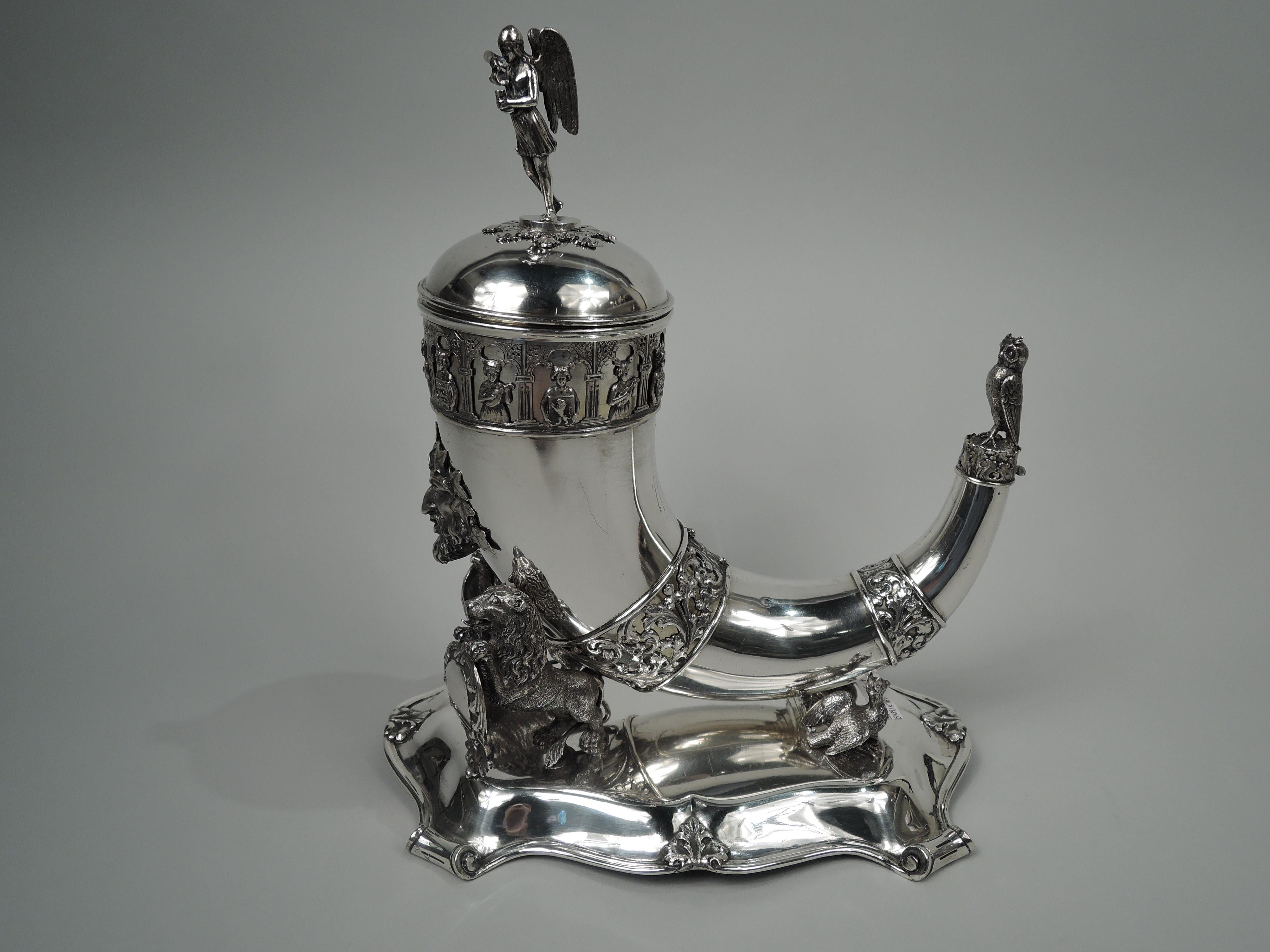 Danish Biedermeier Gothic Troubadour silver horn on stand, 1855. Horn has two applied bands with leafing scrollwork and cast green man applied to front. At top a third band with mandolin-strumming maidens and coat of arms-bearing pages in cloister