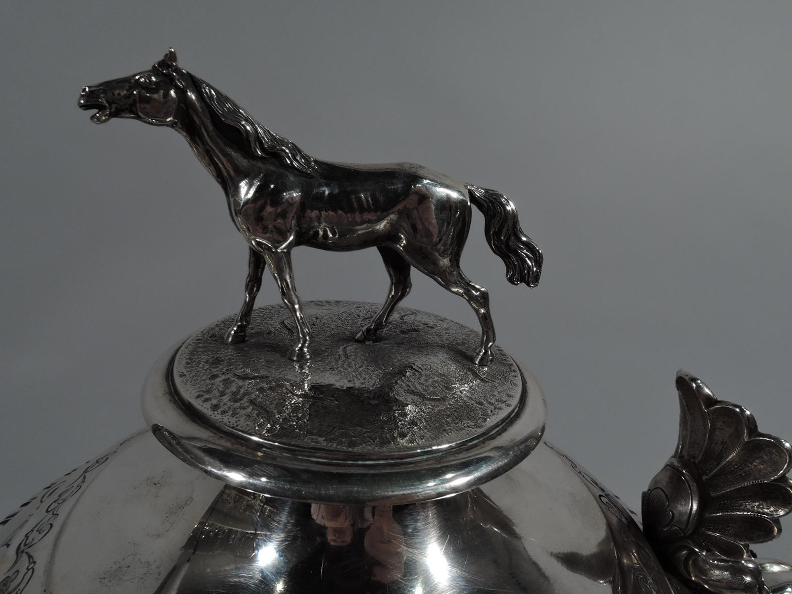 Antique Danish silver tankard trophy cup. Baluster on domed foot with four scroll-mounted paw supports. Cover hinged and double-domed with cast horse finial. S-scroll handle with elaborate leaf thumb rest, cap, and mounts. Classical ornament and